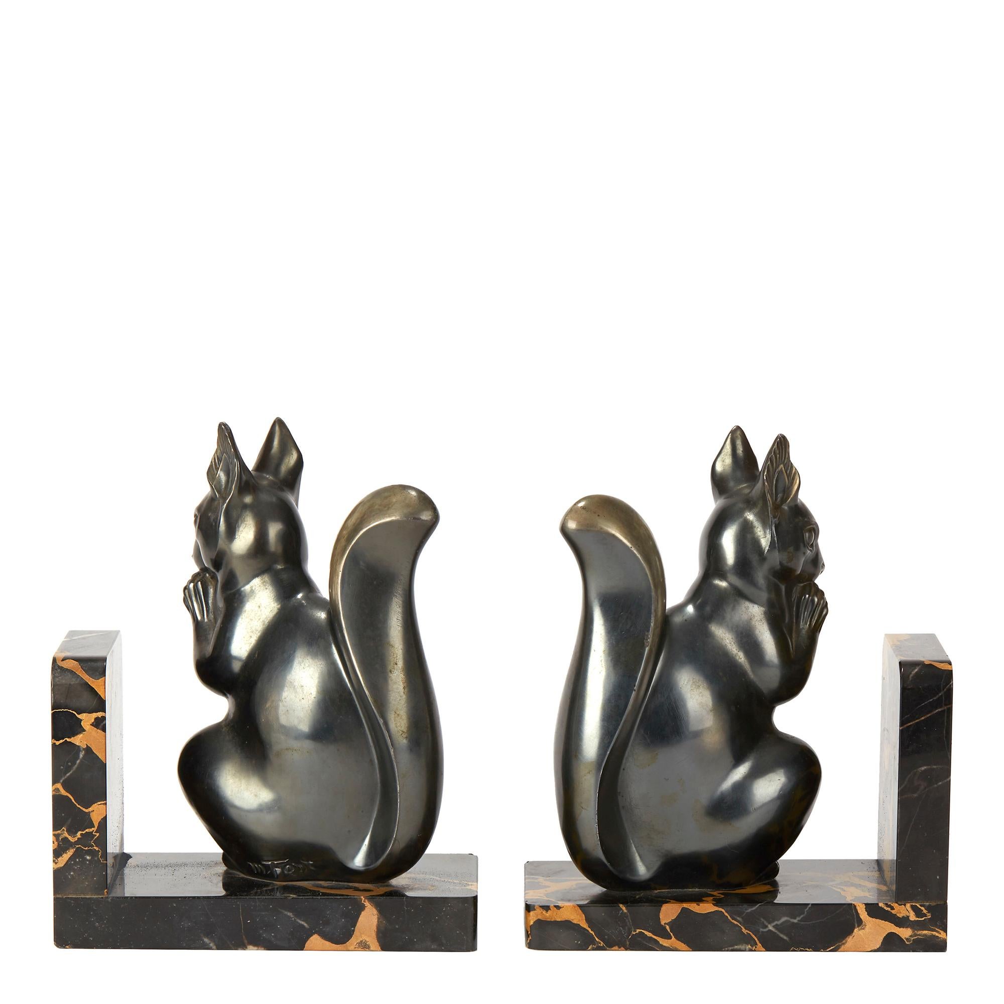 PLEASE NOTE: This piece is currently located in our Amsterdam office, please enquire for delivery times. 

A very stylish pair French Art Deco bookends each mounted with a seated squirrel its tail raised and eating a nut and signed Maurice Font. The