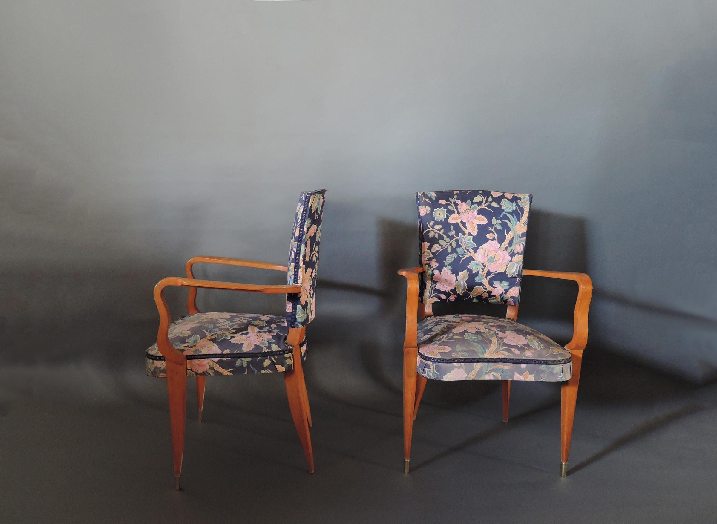 A pair of French Art Deco orange stained beech armchairs with brass sabots.