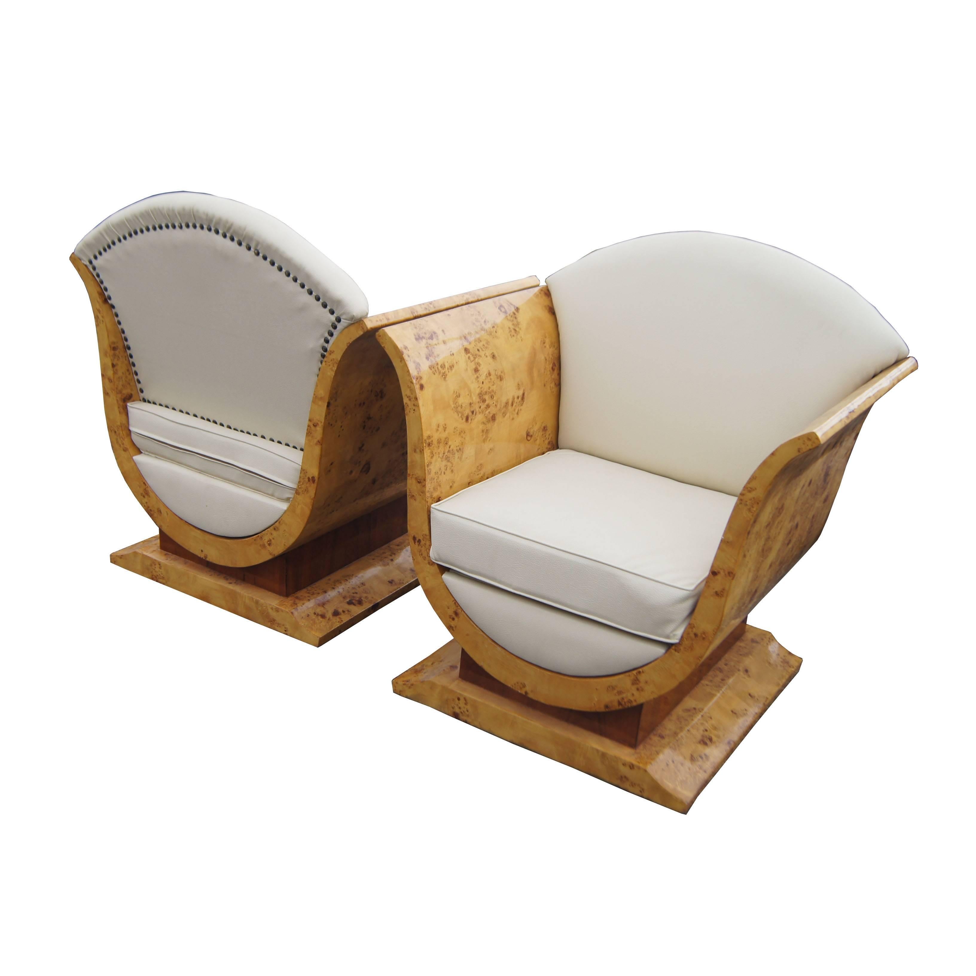 Pair of burled olive wood French Art Deco Style lounge chairs. Features a beautiful burled wood pattern and elegant curved lines on the arms as well as a burled square pedestal base.