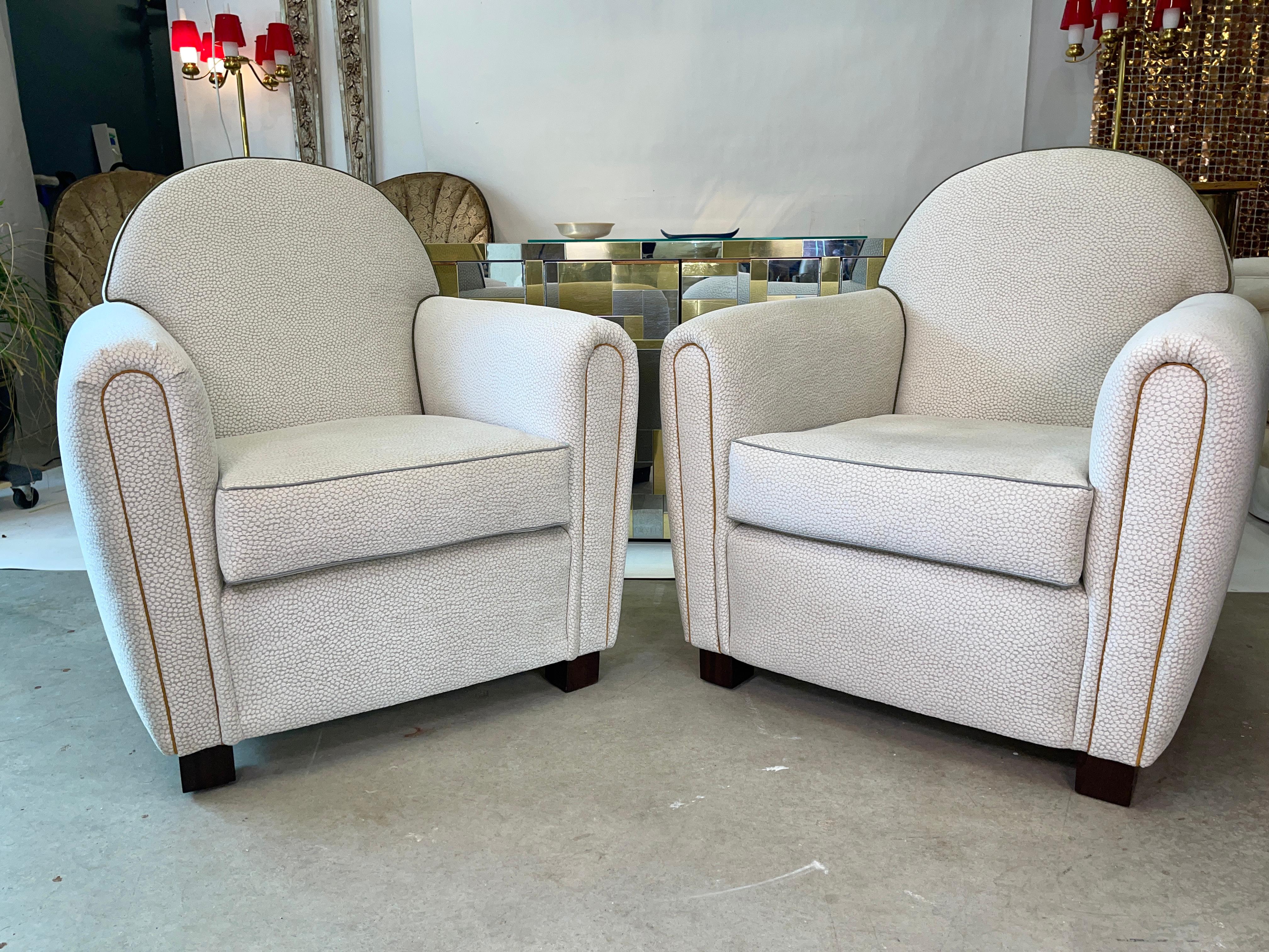 Pair of custom made club chairs inspired by Jean Michel Frank, upholstered in Thibaut fabric with contrasting cording. Tight back with polyester wrapped Ultracel foam core seat cushion, and ebony stained mahogany feet.

 
Fabric: Thibaut “Kali” in