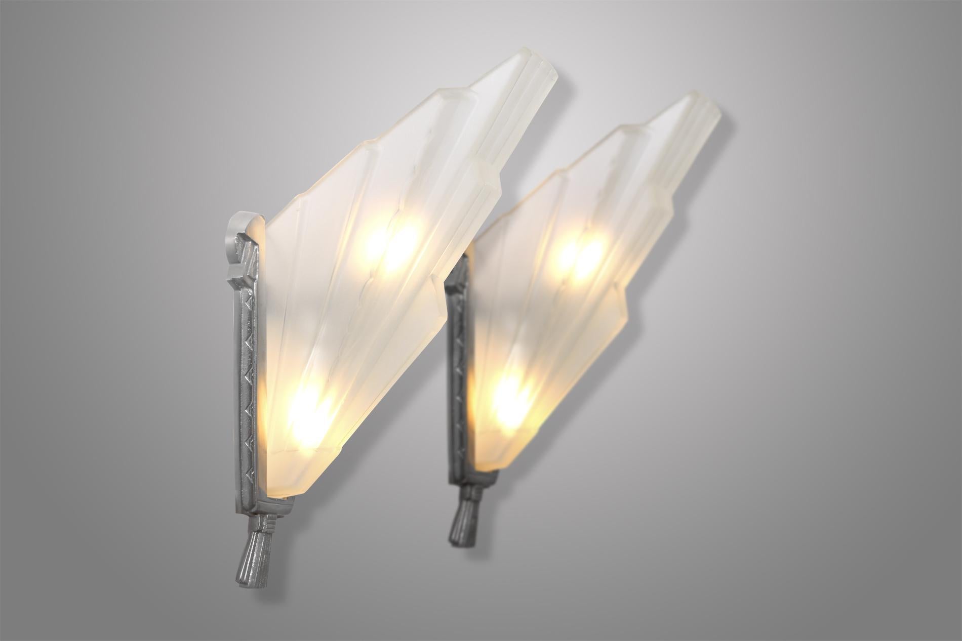 Pair of Sabino Art Deco sconces in glass and silvered bronze from 1930. This is the biggest model as the small version exists too. 

The design of the sconces is elegant, timeless and would suit any contemporary interior.
   