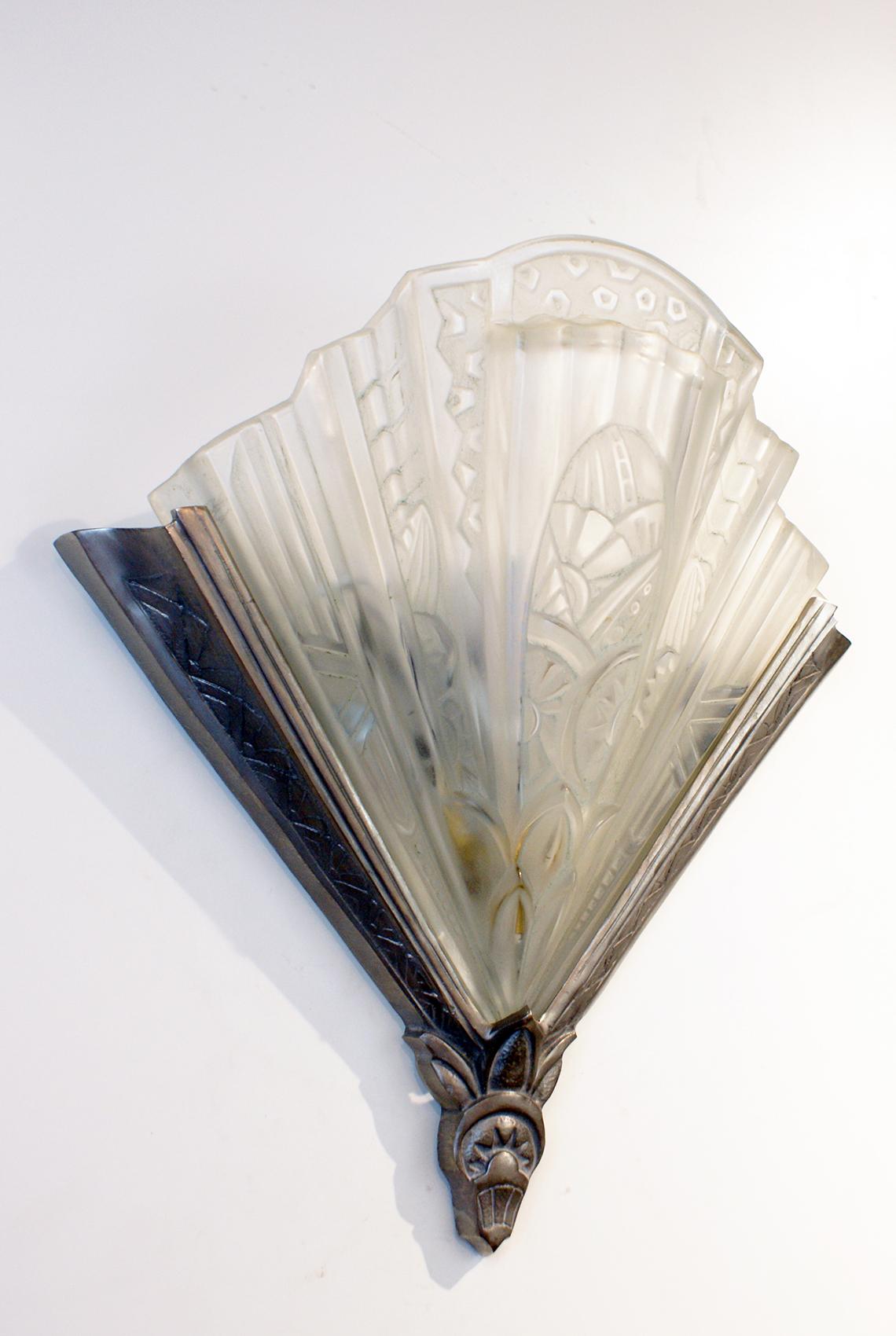 A stunning pair of French Art Deco wall sconces in clear frosted glass shades marked 