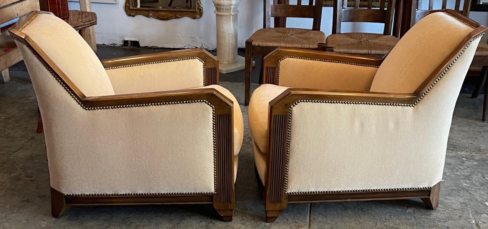 Here is a beautiful pair of art deco armchairs, They are upholstered in the original yellow silk mohair with metal studs. The frame is made of solid walnut.