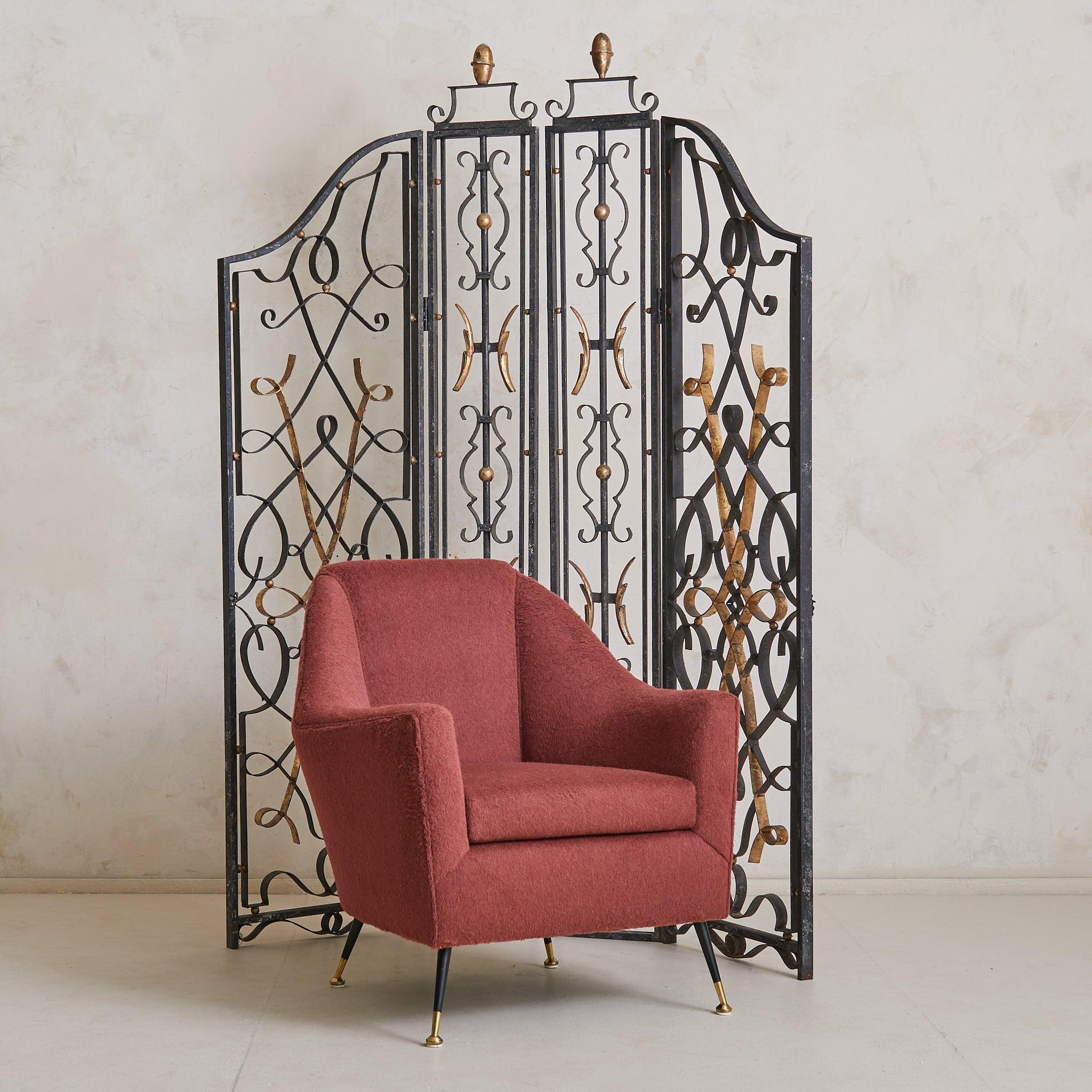 A pair of 1930s French Art Deco screens in the manner of Gilbert Poillerat, crafted in wrought iron with sinuous, interlacing curves and delicate gilt accents. These sculptural room dividers evoke the lyricism and precision of Poillerat’s celebrated