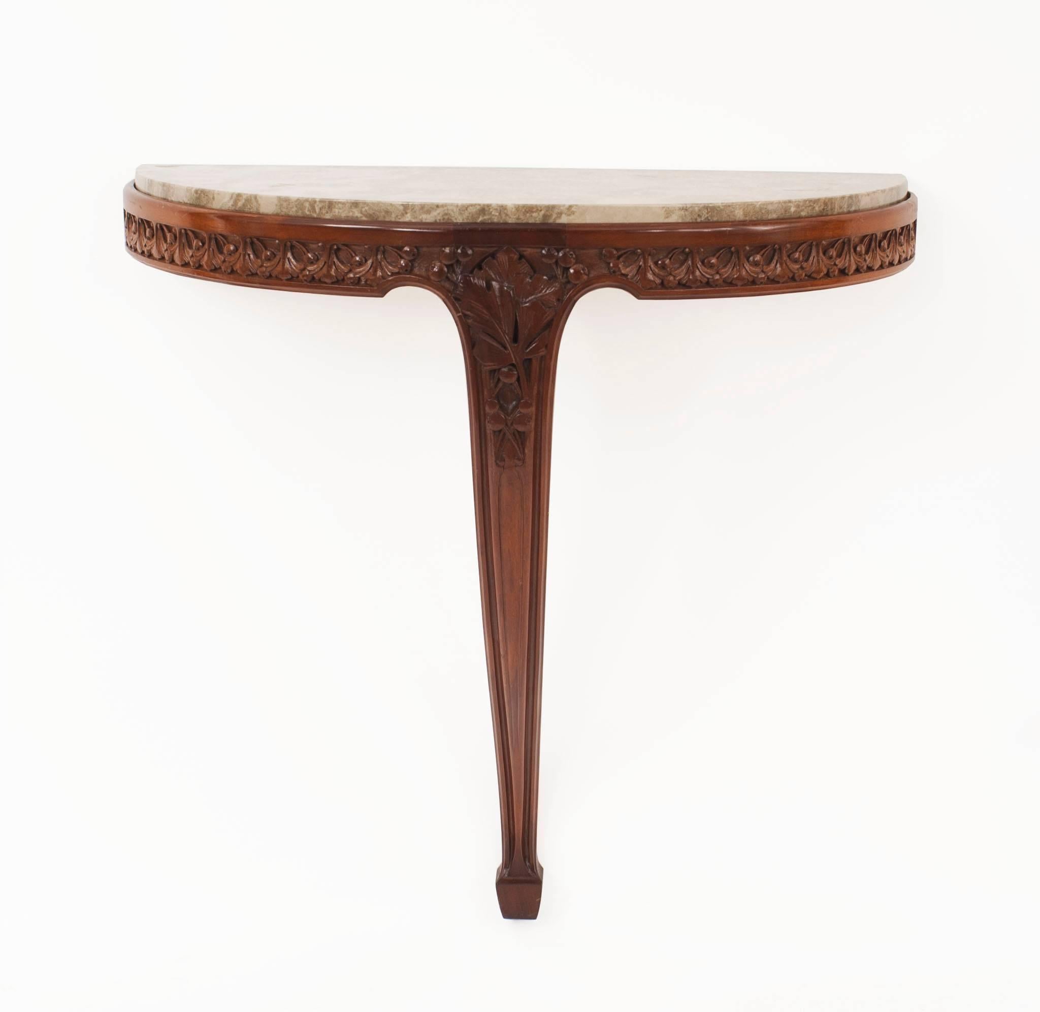 Pair of French Art Nouveau mahogany bracket console tables with a floral carved apron supported on a single leg with 