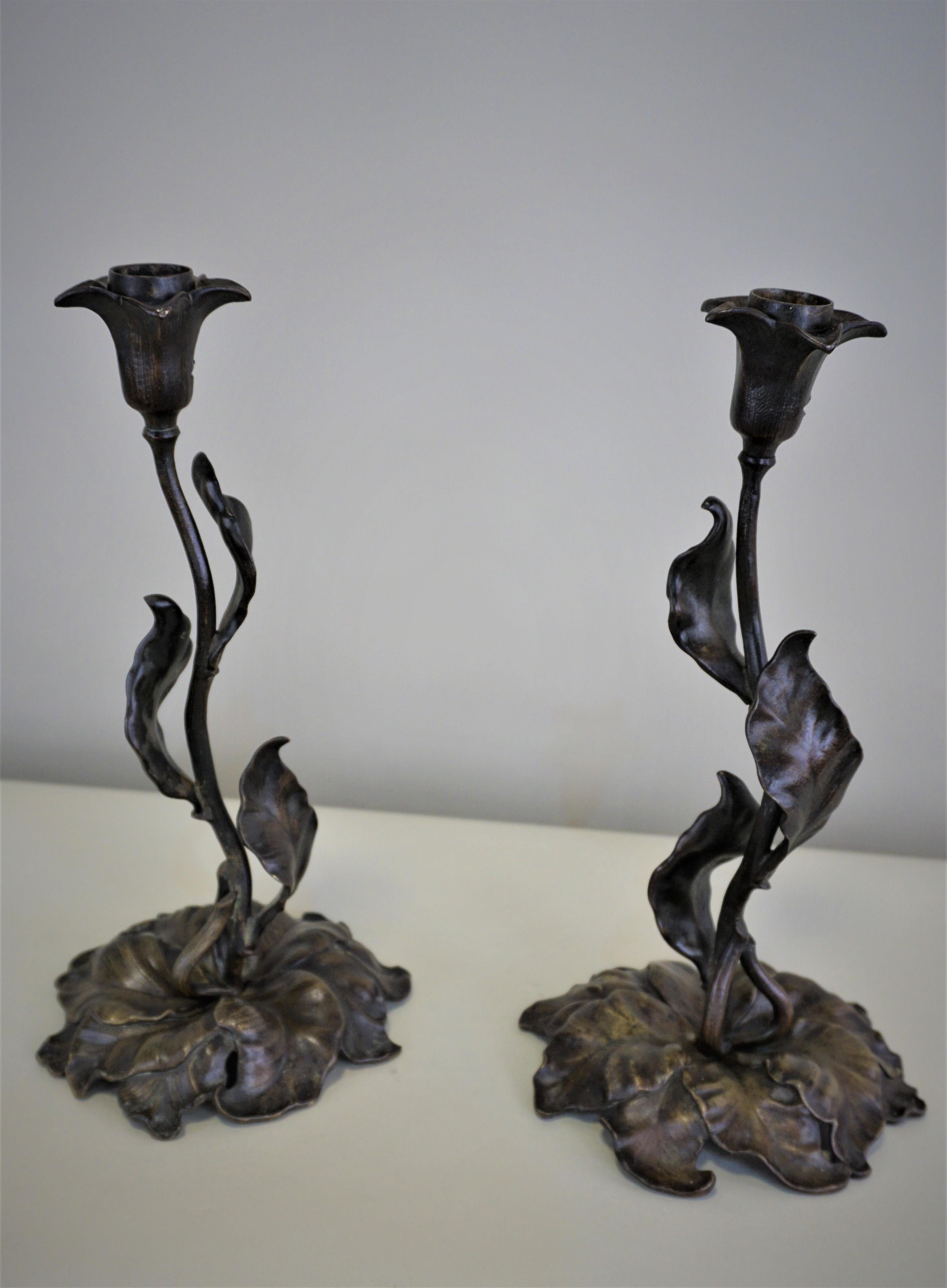 Pair of French Art Nouveau dark bronze leaf design candlesticks.