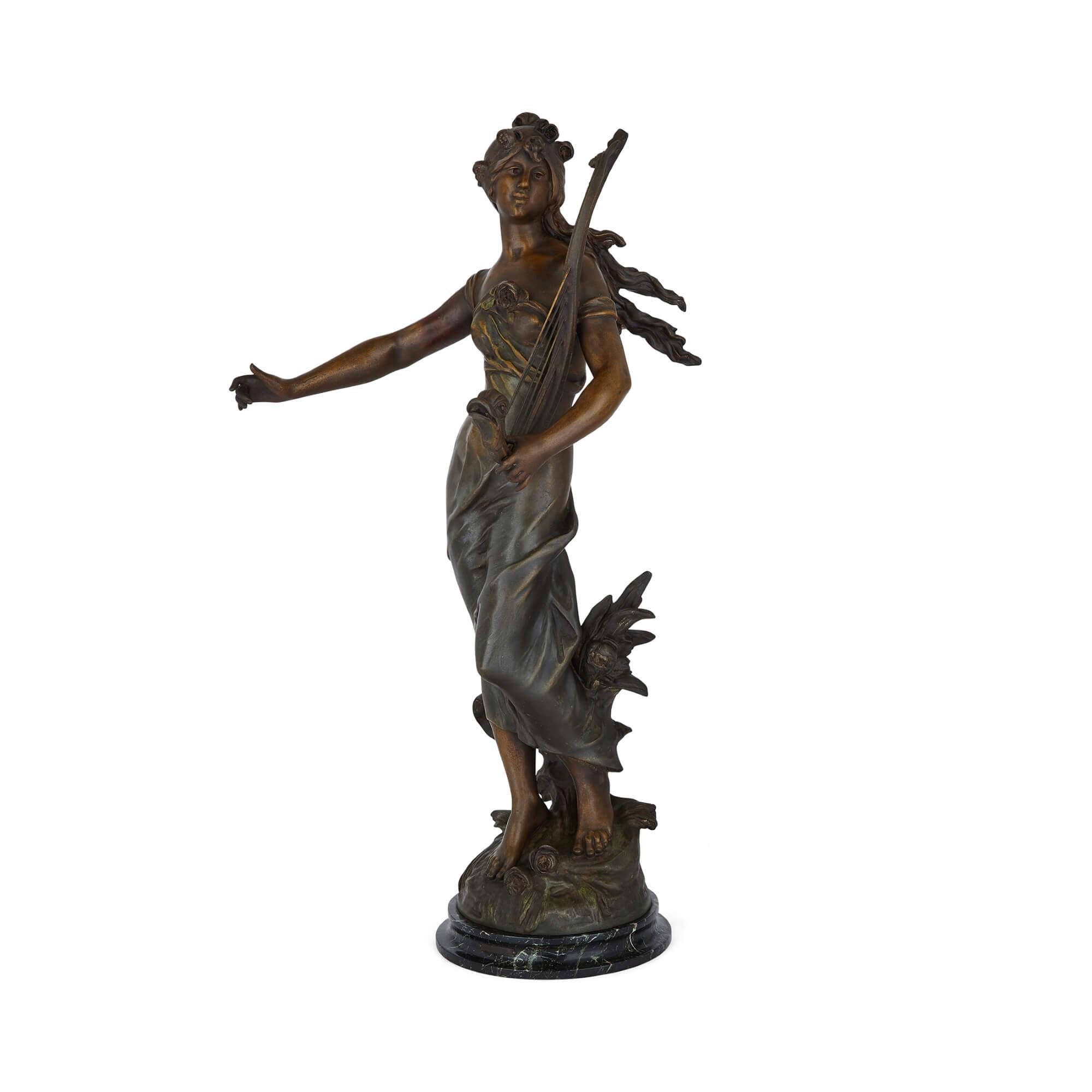 Pair of French Art Nouveau patinated spelter sculptures
French, early 20th century
Measures: Figure with lyre: Height 92cm, width 48cm, depth 38cm
Other figure: Height 90cm, width 52cm, depth 33cm

The spelter works in this pair are after two