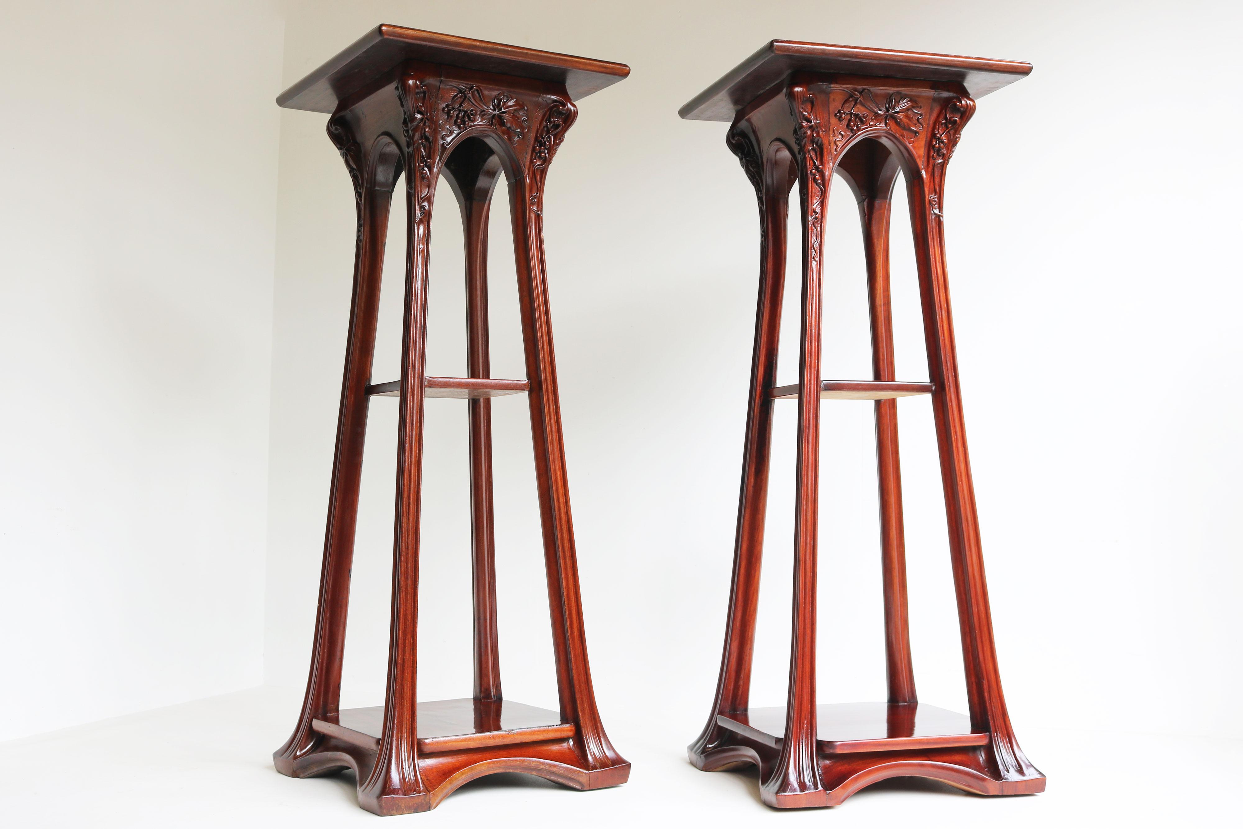 Exquisite pair of stylized Art Nouveau plant stands / pedestals by Louis Majorelle designed in 1907 with carved ''Vigne Vierge'' decorations.
Each pedestal has 3 tiers and the top tiers rotate 360 degrees. Exquisite crafted and fully hand carved