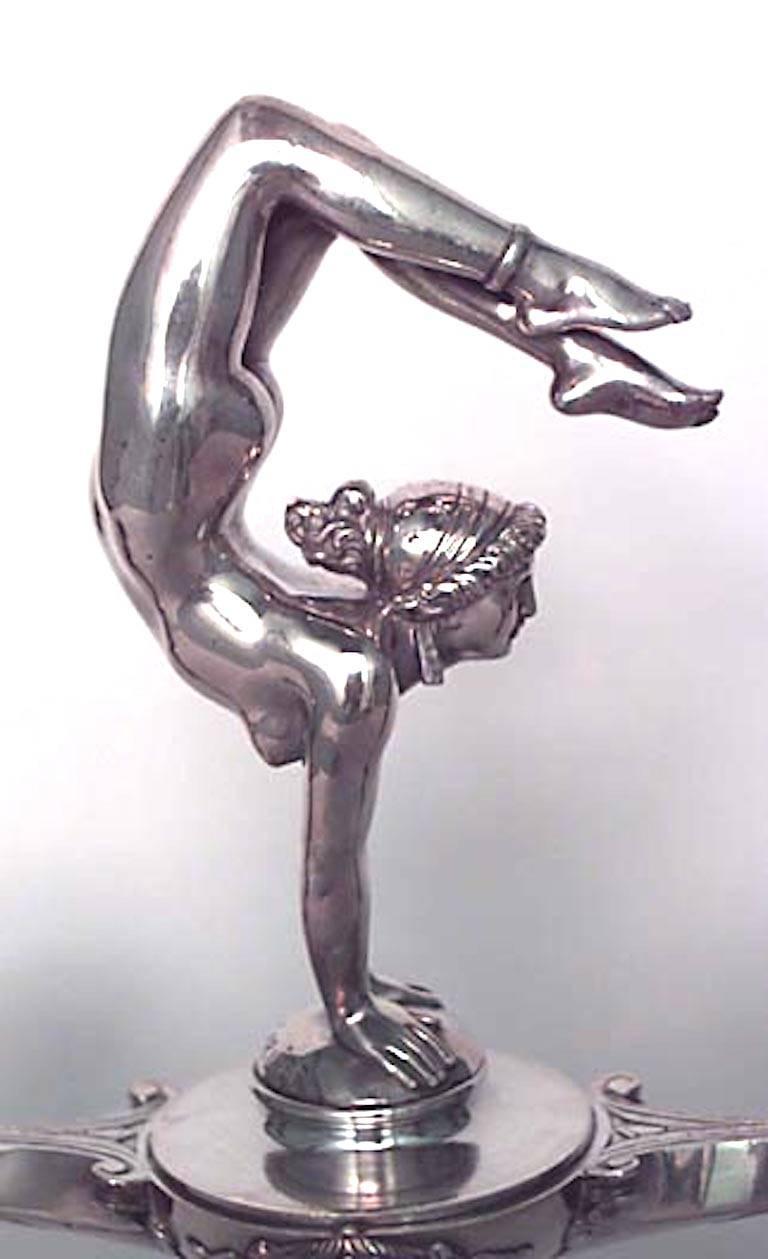 Pair of French Art Nouveau silver-plate over bronze candelabra with centered lady acrobat standing on hands between 2 urn design candle holders (signed E. CARLIER) (PRICED AS Pair)
