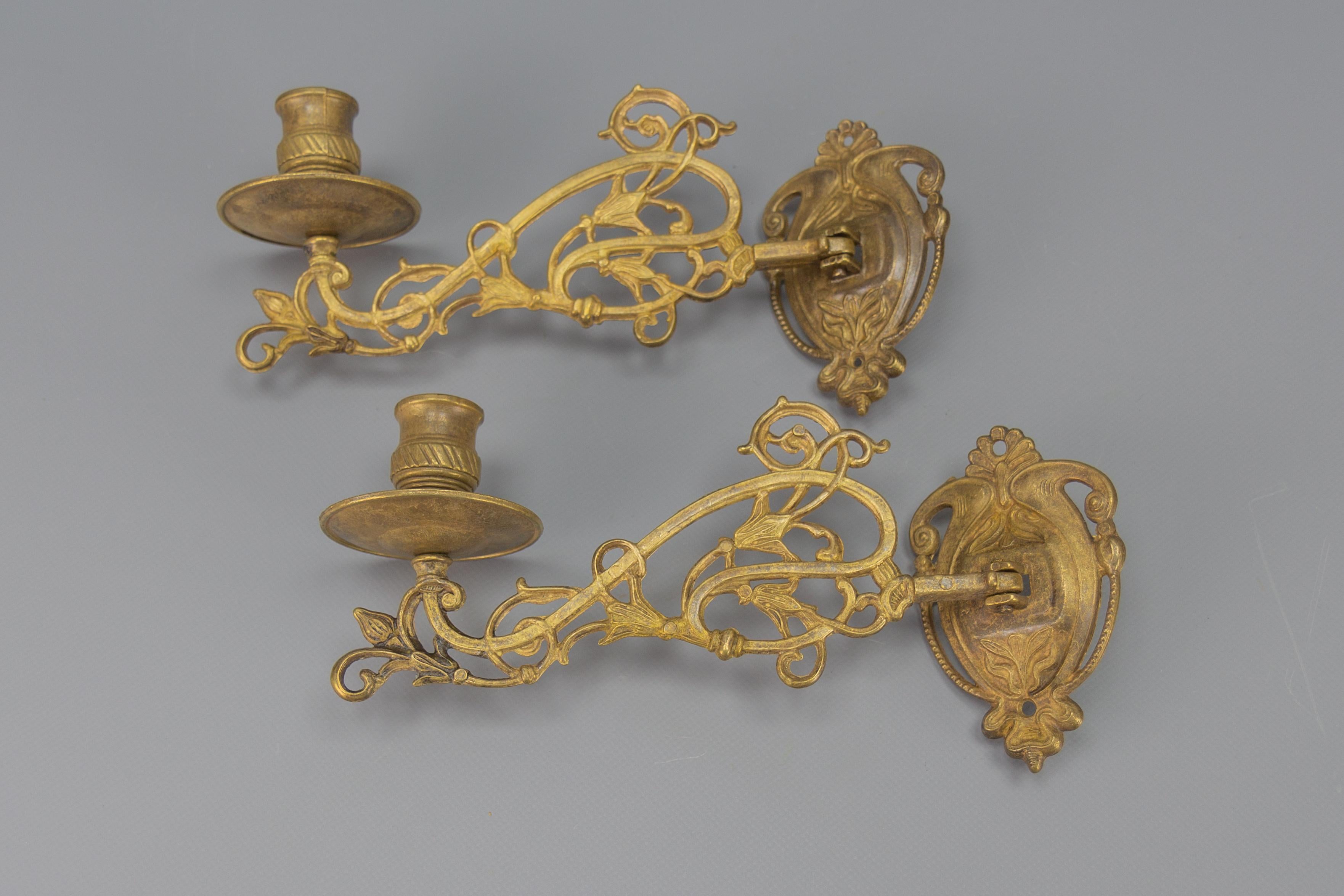 An ornate pair of French Art Nouveau style piano or wall lights, candleholders from circa the 1950s. Each sconce has one arm for one candle, decorated with beautiful Art Nouveau-style flower motifs. Made of metal and brass.
Dimensions: height 12 cm