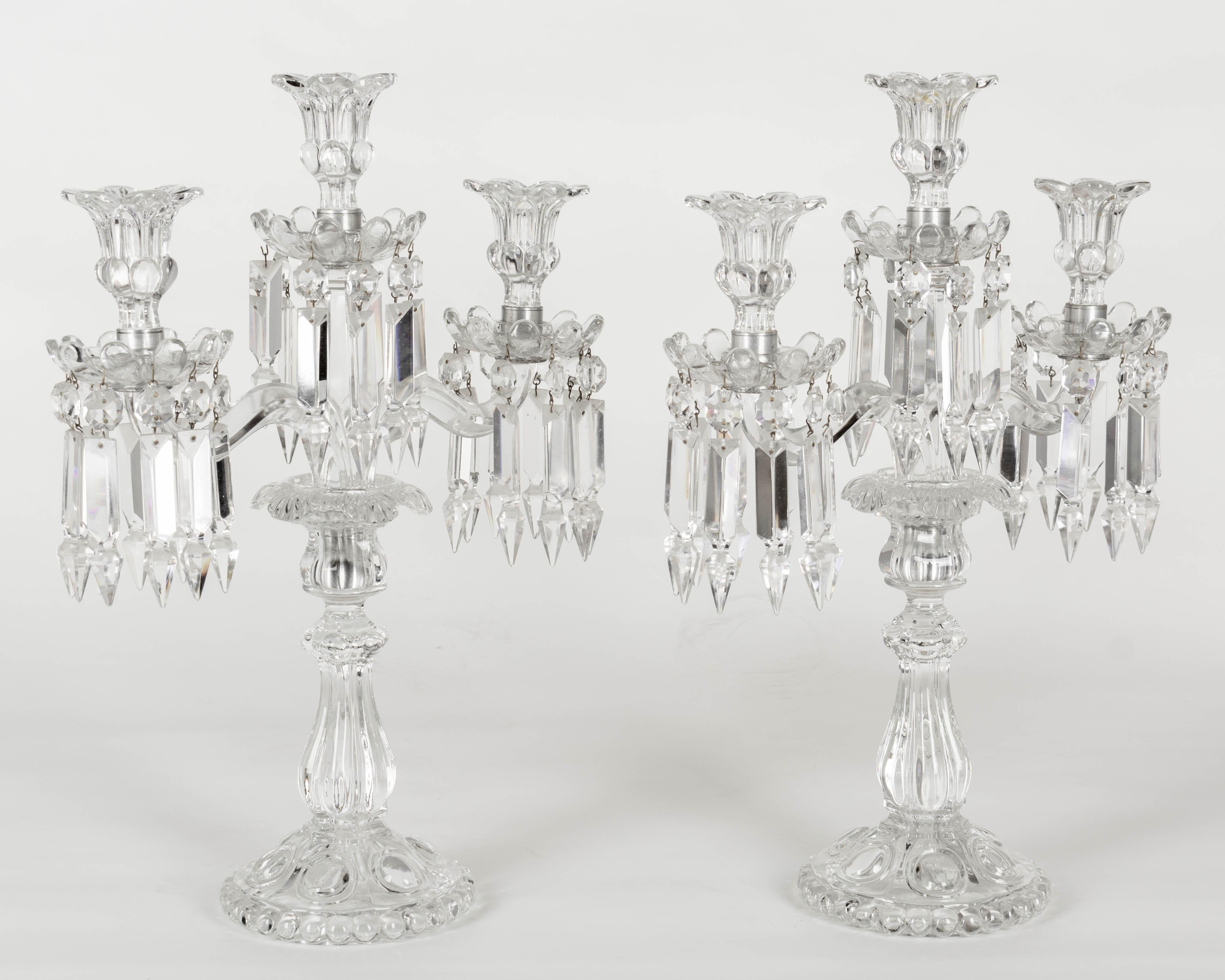 A pair of French Art Deco Baccarat crystal 3-light, two arm candelabras with Albert drop prisms and removable bobeches.
