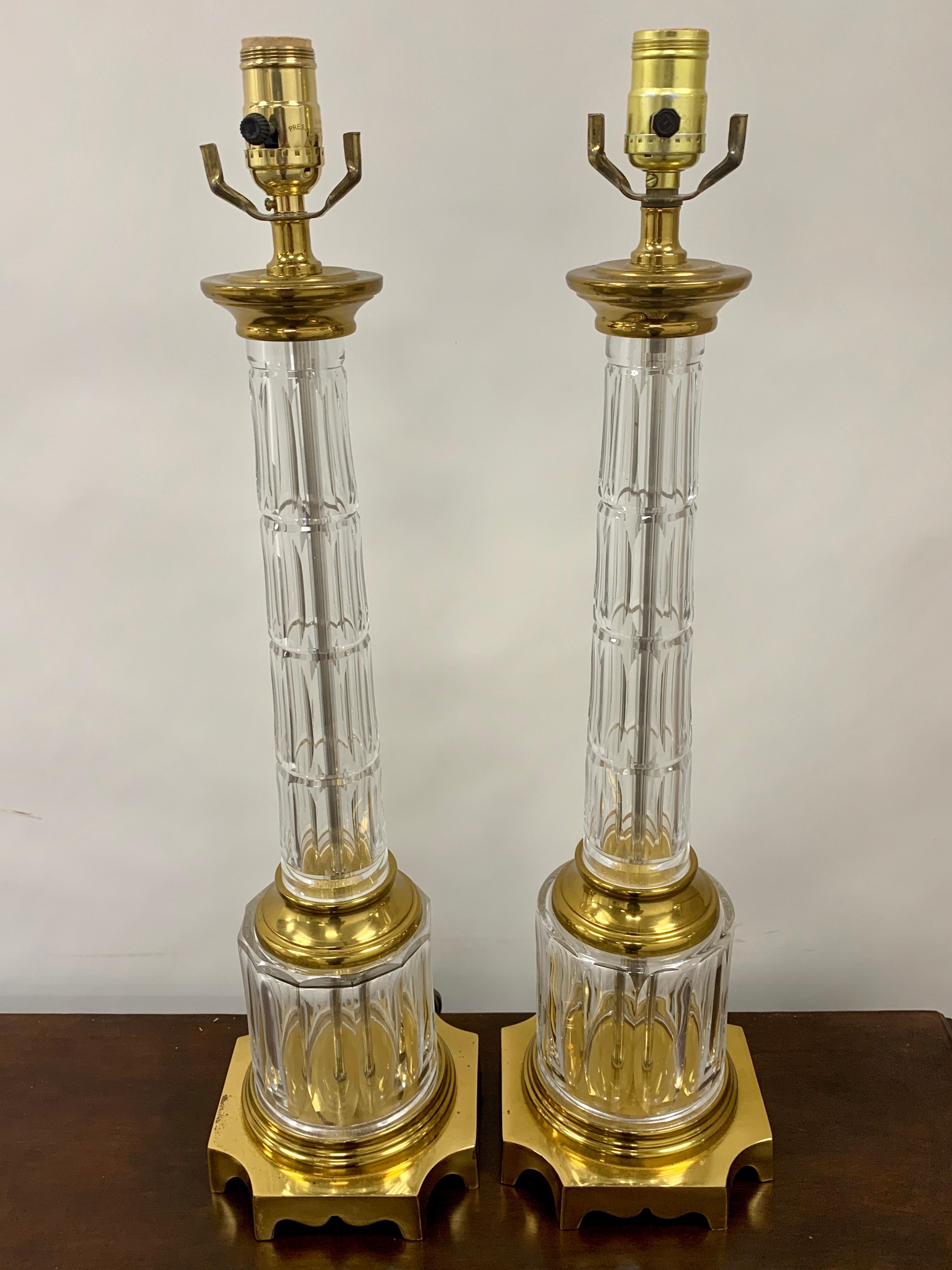 Pair of French Baccarat style cut glass column lamps, each one in the neoclassical style, with panel cut column and base, raised on brass square base. Each lamp has a 6.5