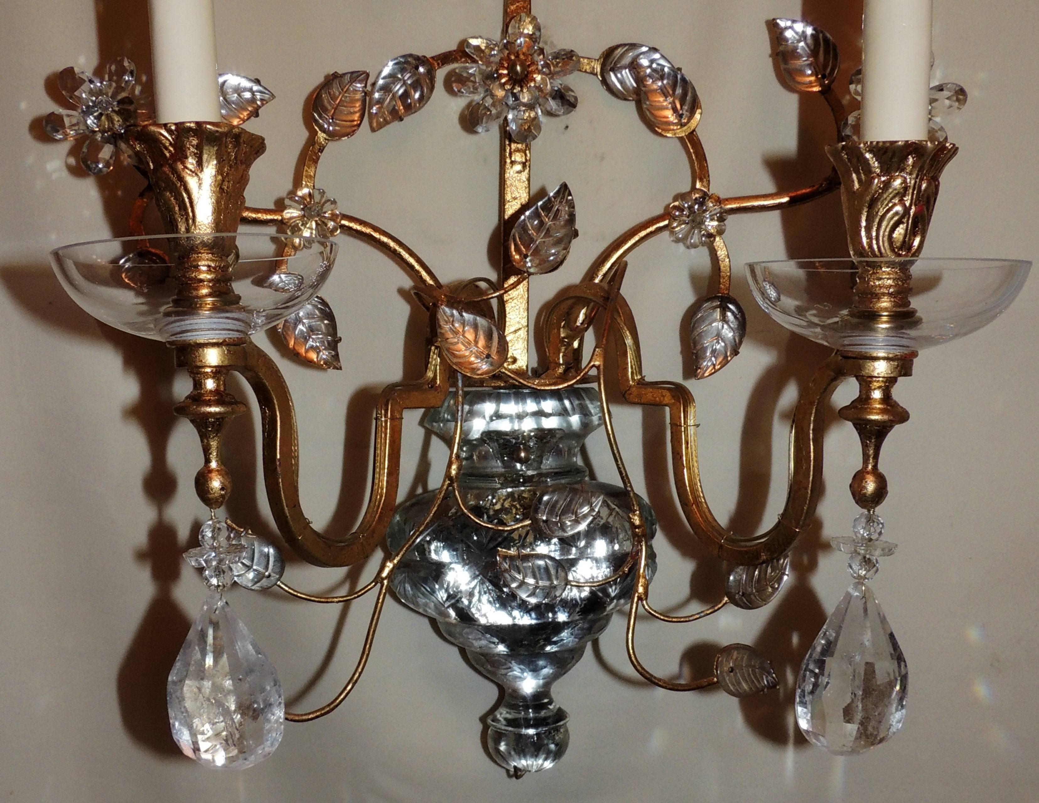 A wonderful pair of French rock crystal, gold gilt with glass urn center two-arm sconces in the manner of Baguès & Jansen.