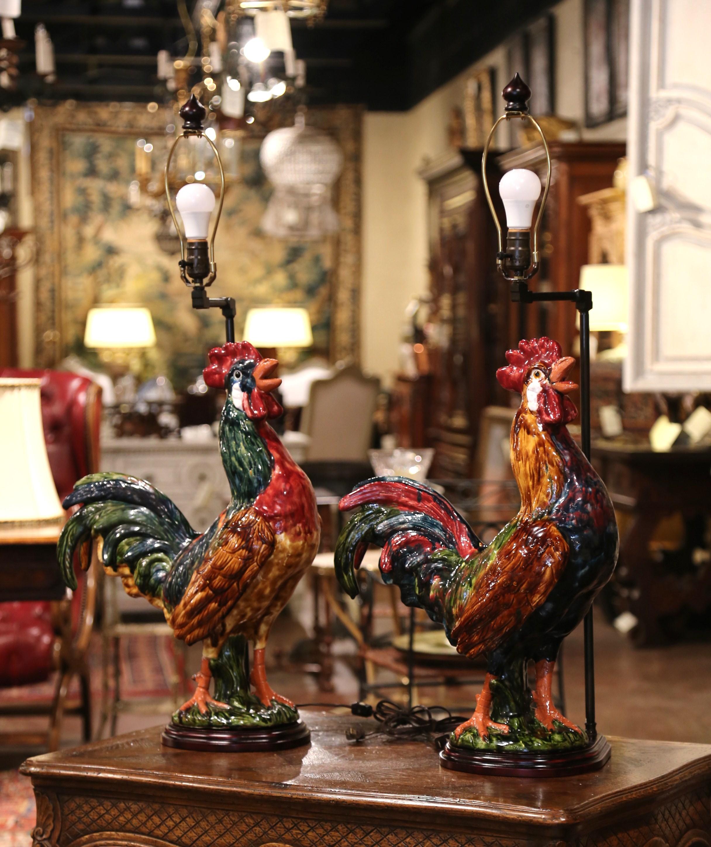 Bring a little country French flair into your home with this colorful pair of lamps. Crafted in Normandy, France, the Majolica roosters are hand painted and have been made into large table lamps. Each fixture stands on a wooden base, has new wiring