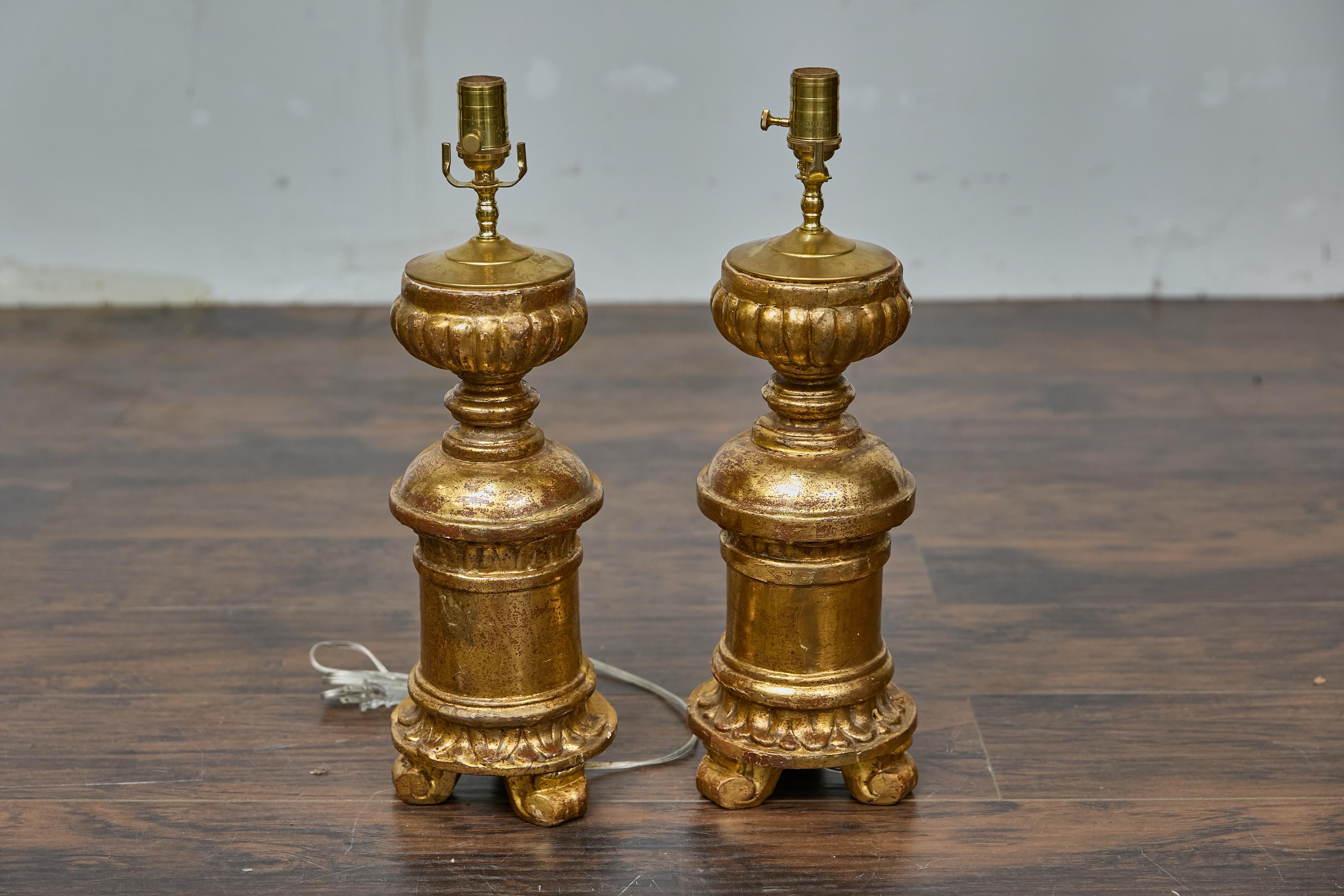 A pair of French Baroque Revival 19th century giltwood fragments made into modern table lamps wired for the USA. Infuse a sense of regal antiquity into your space with this pair of French 19th-century giltwood fragments, now transformed into