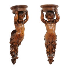 Pair of French Baroque Style 1810s Walnut Wall Sconces with Carved Putti