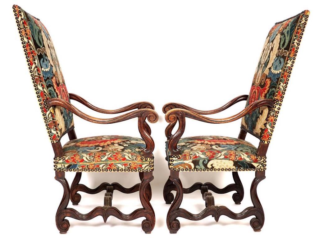 Pair of well carved Baroque needlework armchairs. Colorful but later needlework probably 19th century in period form.