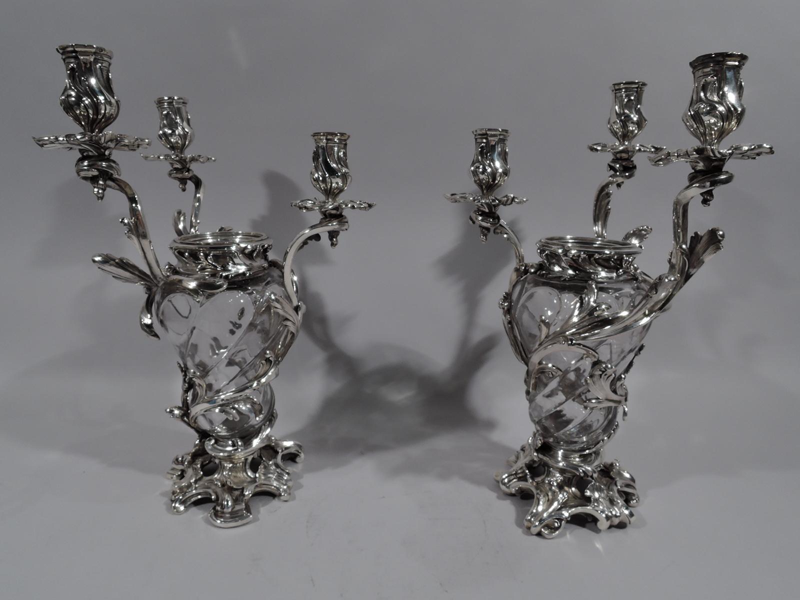 Pair of dramatic French Belle Époque Baccarat crystal and silver vase candelabra, circa 1890. Each: Lobed baluster crystal vase with wraparound silver leafing, each terminating in single leaf-wrapped socket with petal wax pan. More leafing applied