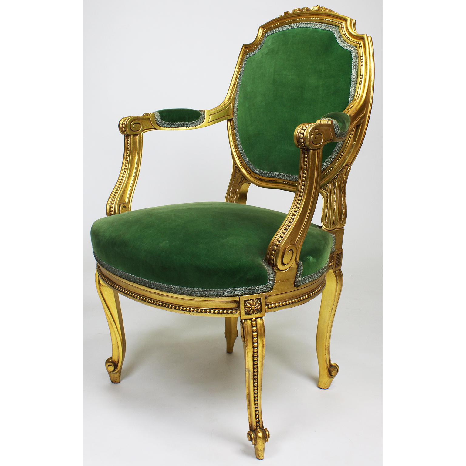 A pair of French Belle Époque Louis XV Style Fauteuil à la Reine (Armchairs) Frames. The upholstered backrest with a giltwood carved ribbon, open and padded armrests and cabriolet legs, Paris, circa 1900-1920.

Measures: Height 37 1/4 inches (94.6