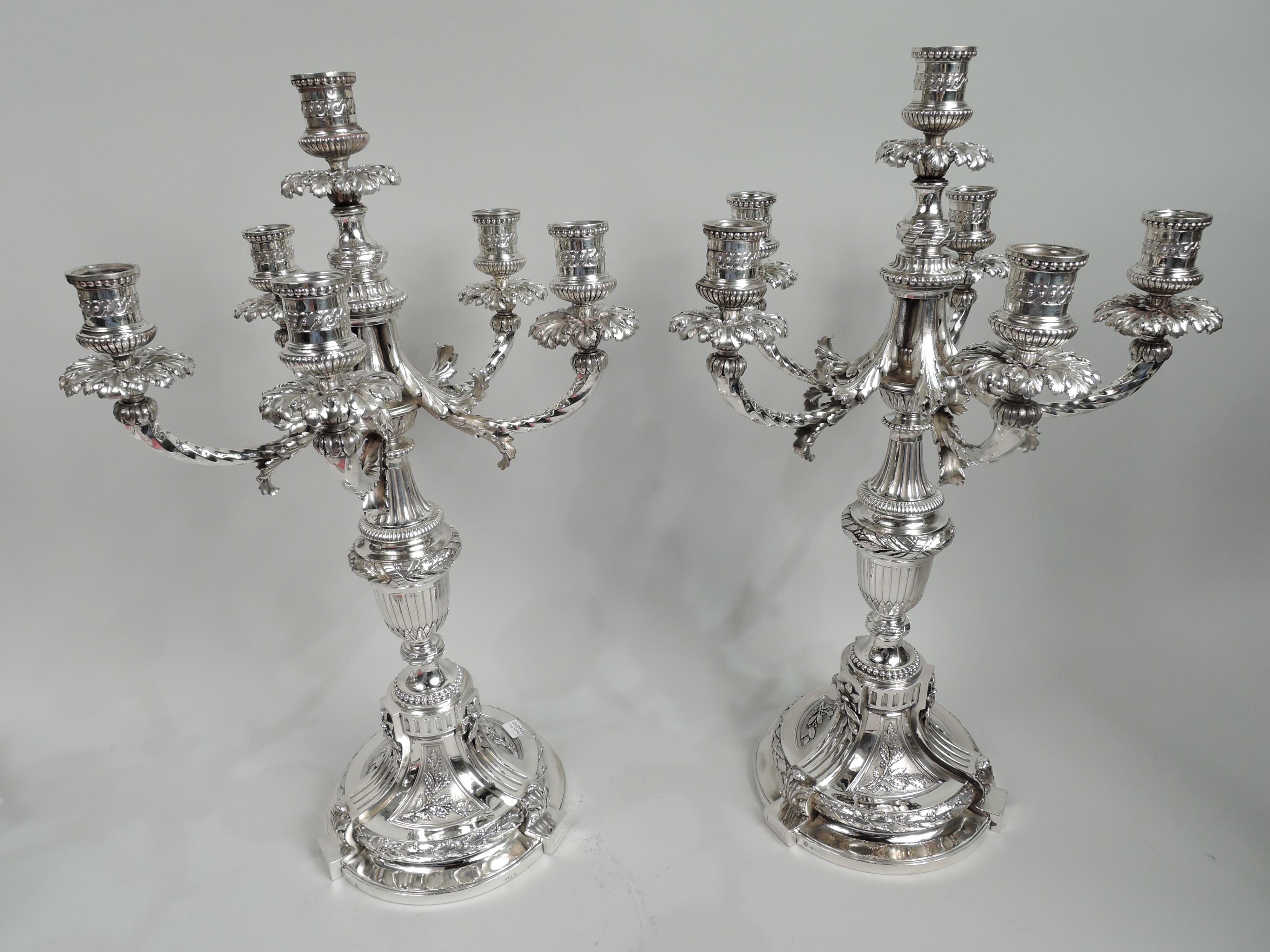 Pair of Belle Epoque neoclassical 950 silver 5-light candelabra. Made by Robert Linzeler & Cie in Paris, ca 1910. Each: Central raised socket four arms each terminating in single socket. Sockets have bellied and gadrooned bottom, guilloche border,