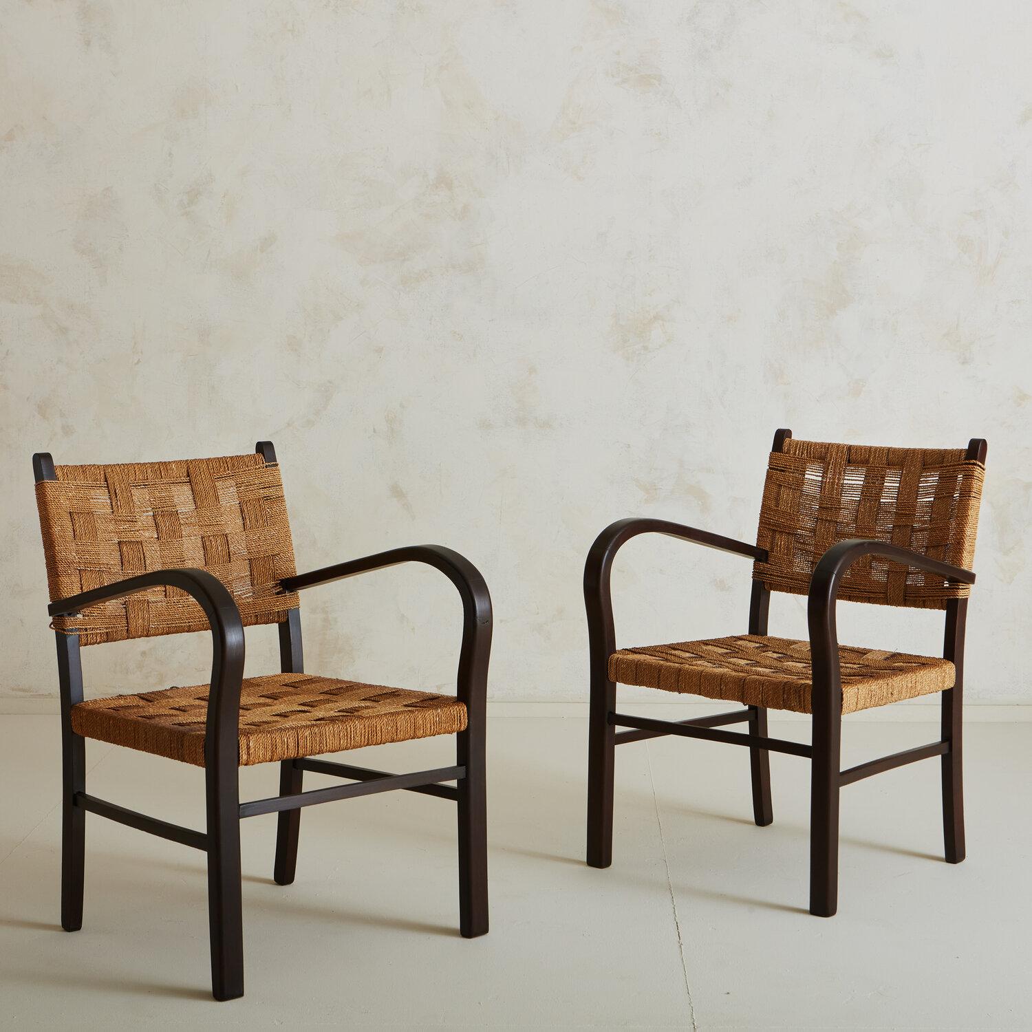 A pair of lounge chairs sourced in the South of France featuring wooded frames and a woven rope seat and back. These chairs blend well with many other design genres and can also float between living spaces.