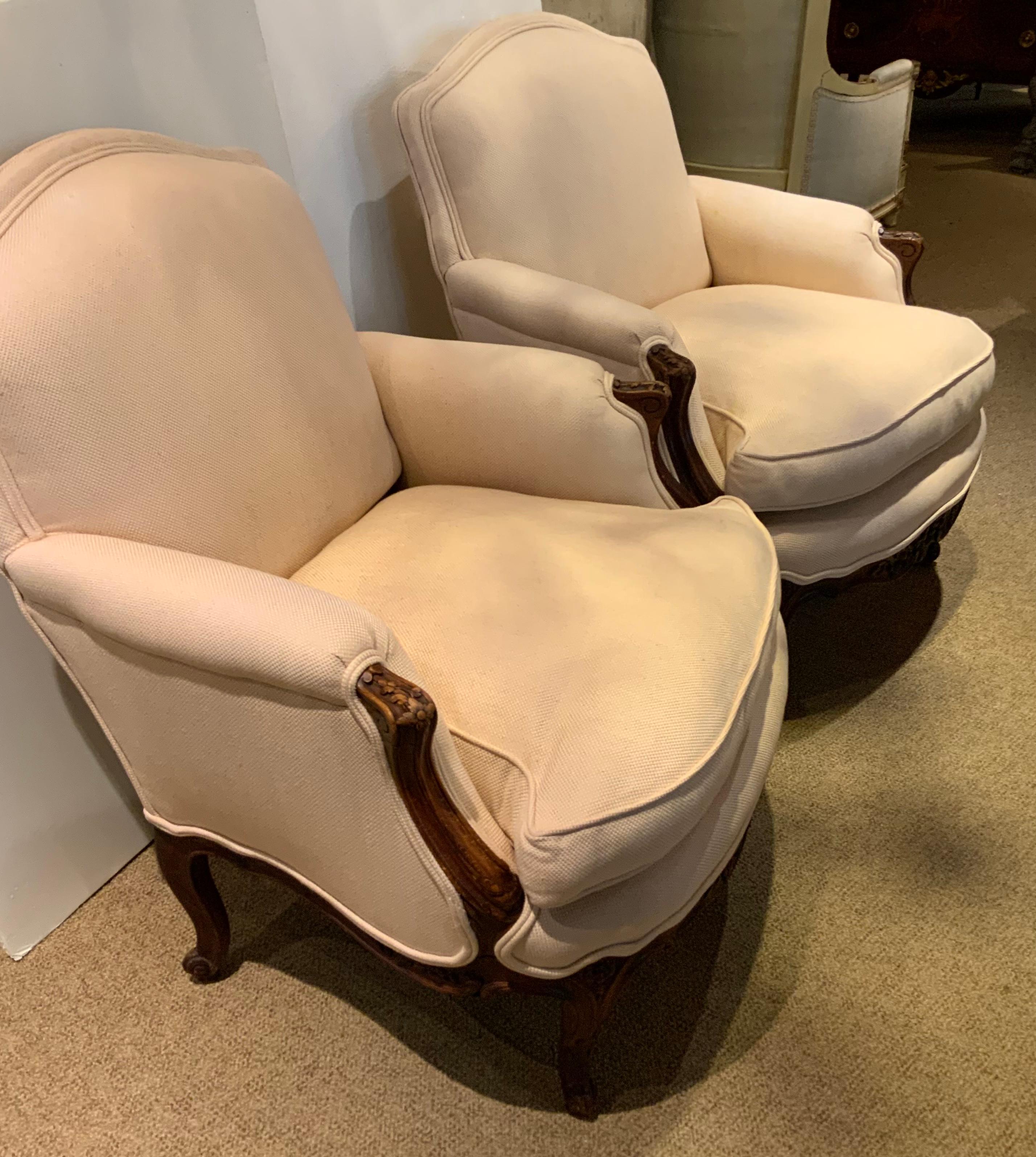 This pair of Louis XV-Style chairs are both beautiful and extremely comfortable 
With a lovely cream colored fabric, they are well padded and have great
Support for the back. The frame is made in a medium colored walnut
And has hand carved floral