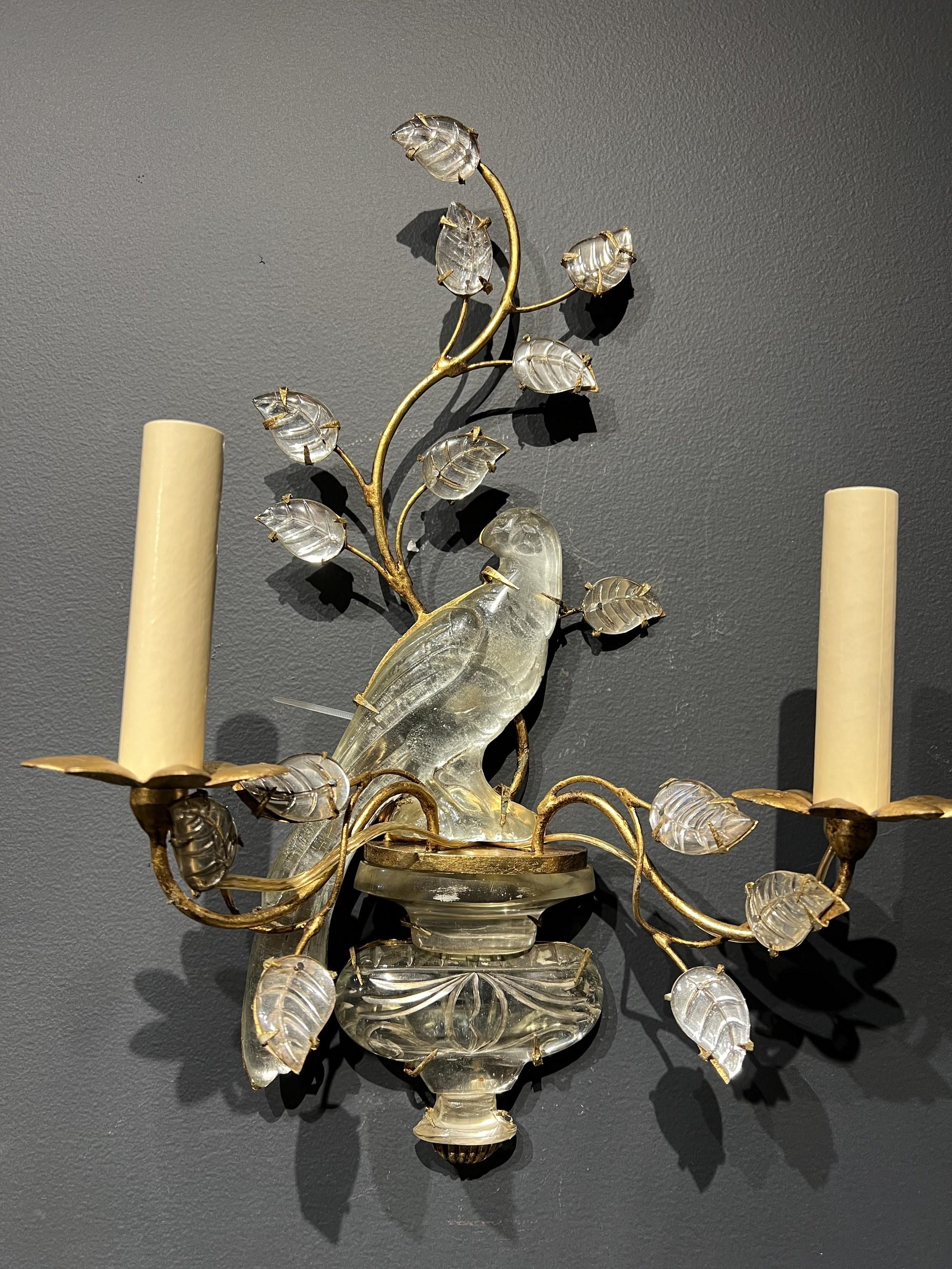 A pair of circa 1940’s French gilt metal bird sconces with glass leaves. In very good vintage condition. 

Up to 120V (US Standard)
Hardwired

Dealer: G302YP
