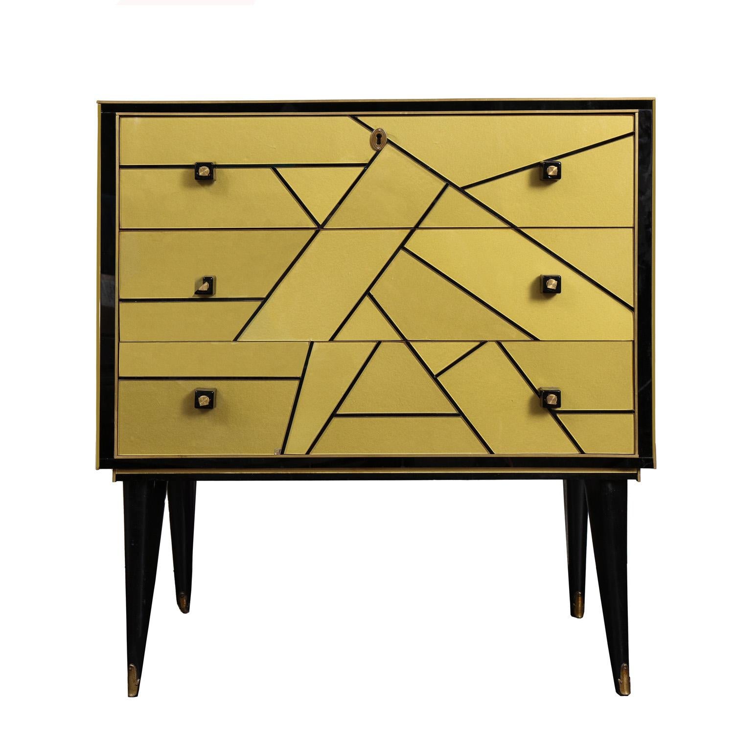Stunning pair of French Art Deco style chest of drawers in black and gold reverse painted glass with art glass hardware and brass edge details and sabot. France, 20th century.