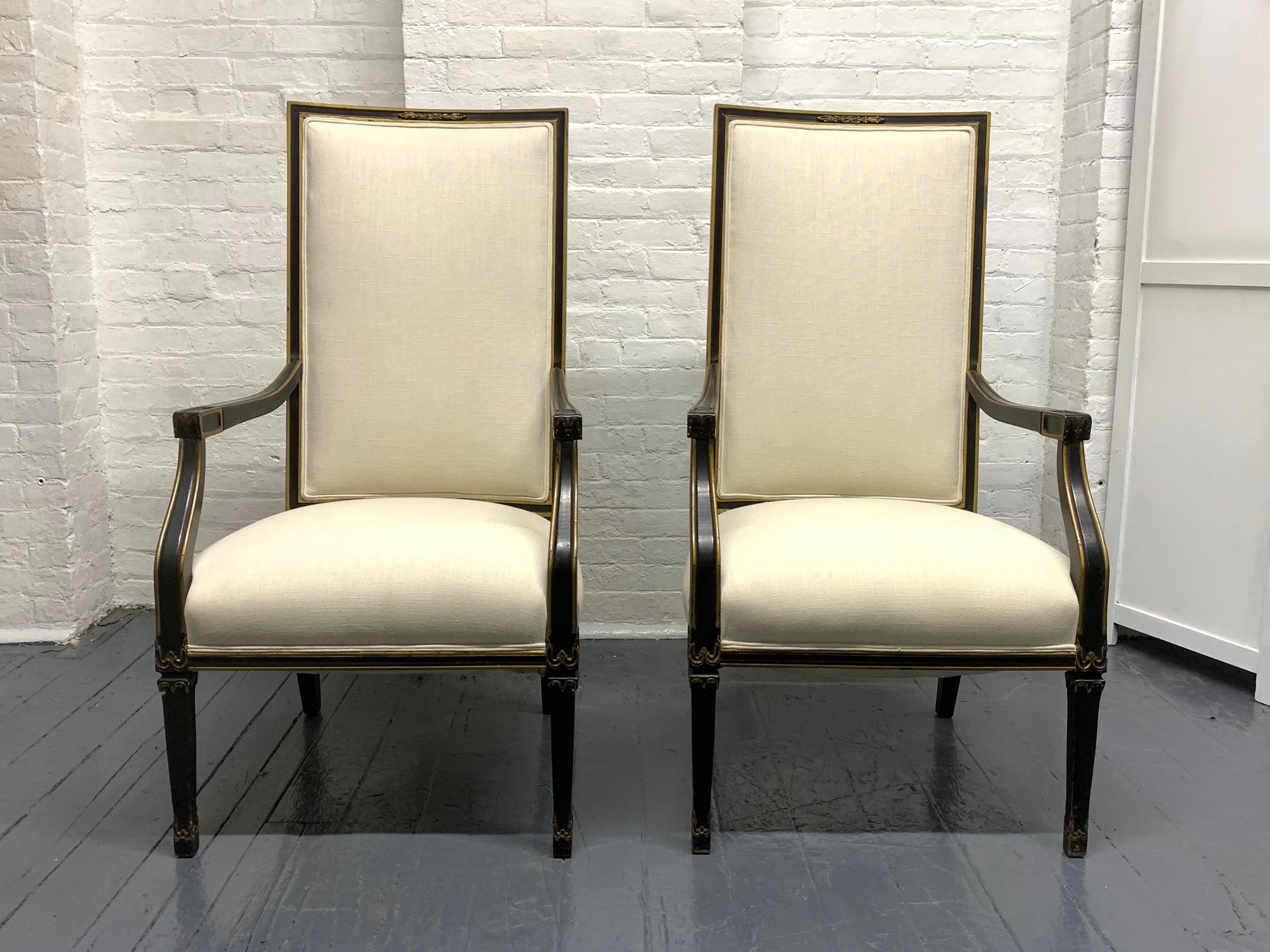 Pair of French black and gold trim side chairs. Upholstered in a linen blend fabric. Hollywood Regency style.
