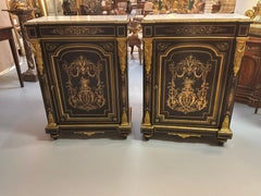 Pair of French black cabinets with gilt bronze scrolling designs
