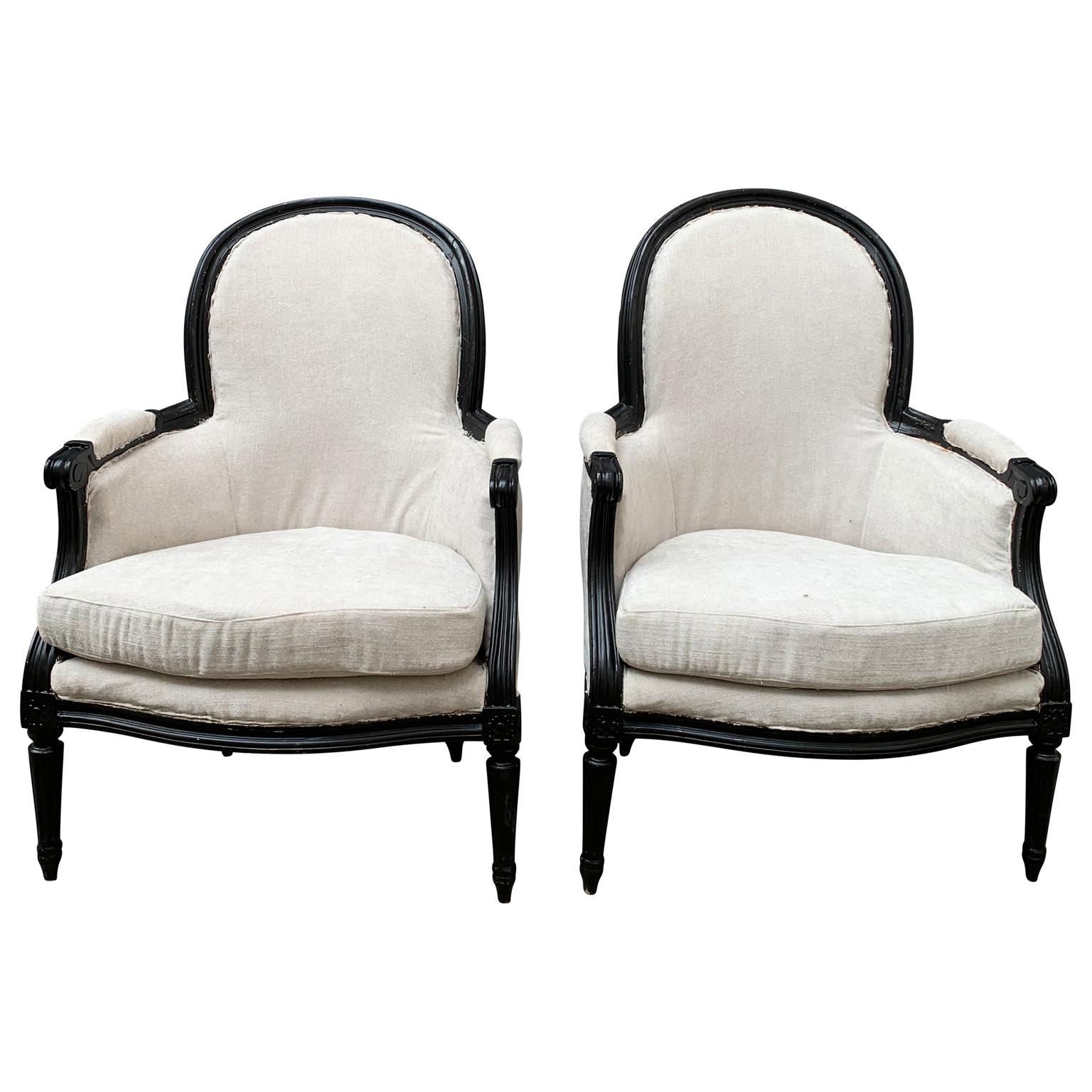 A pair of French bergère armchairs in black painted wooden frame. The armchairs are from the first half of 20th Century and made in the French Louis XVI style.

Please note that these armchairs are located in Sweden.
Complementary delivery to