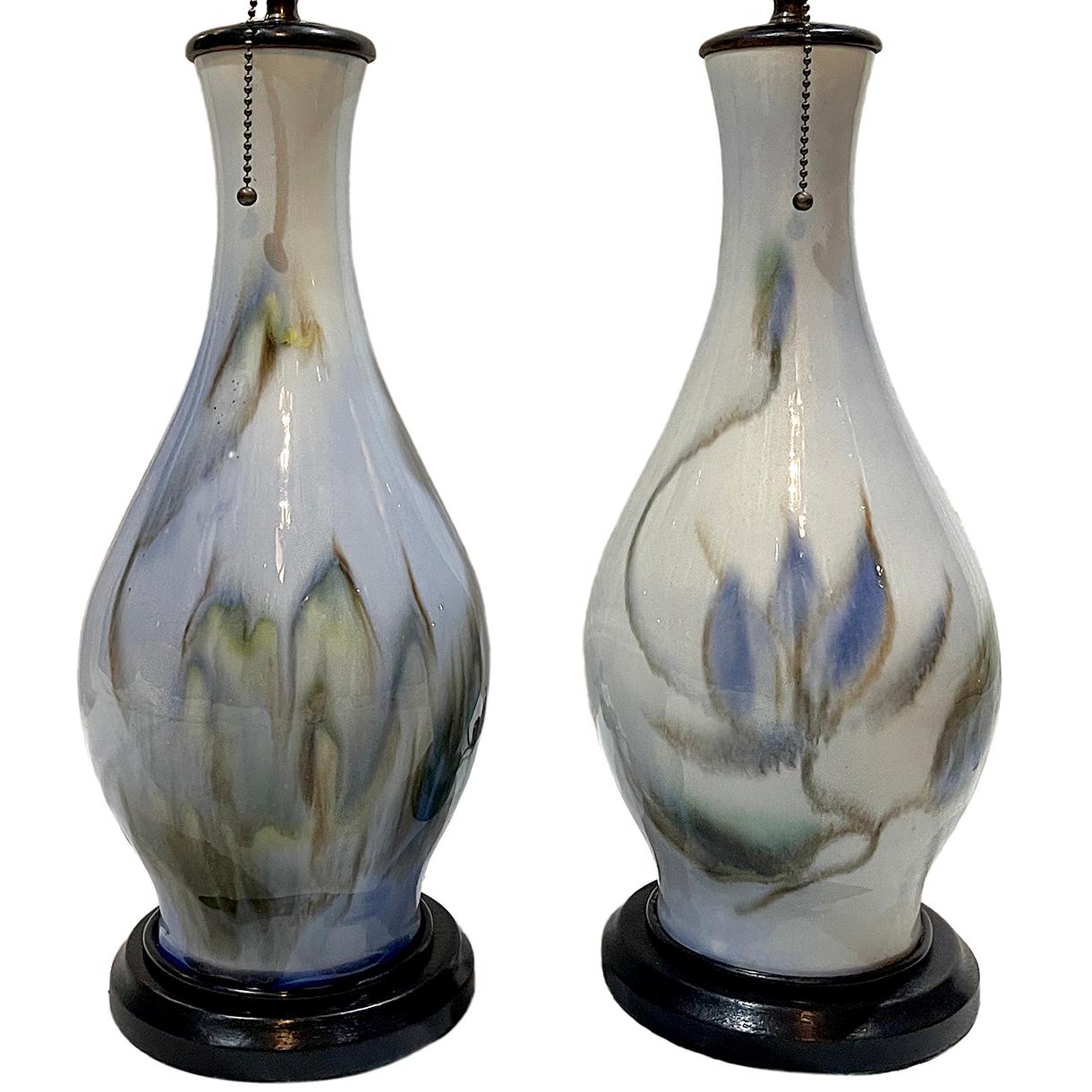 A pair of circa 1950s blue porcelain table lamps with ebonized bases.

Measurements: 
Height of body 16?
Diameter at widest 8