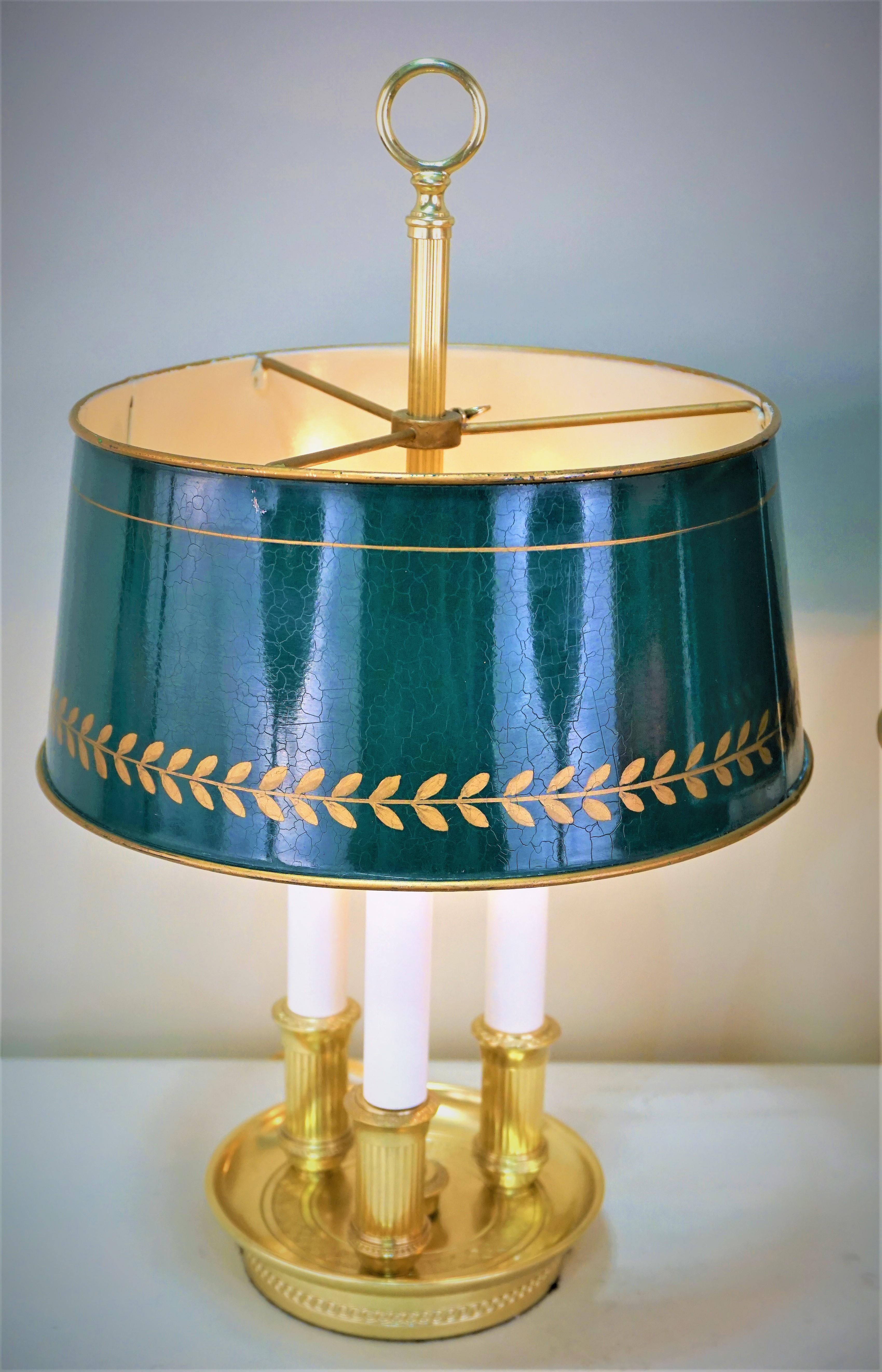 This pair of wonderfully designed three-light desk lamps were crafted in France. Made of bronze, this lamps features an round base tole shades.