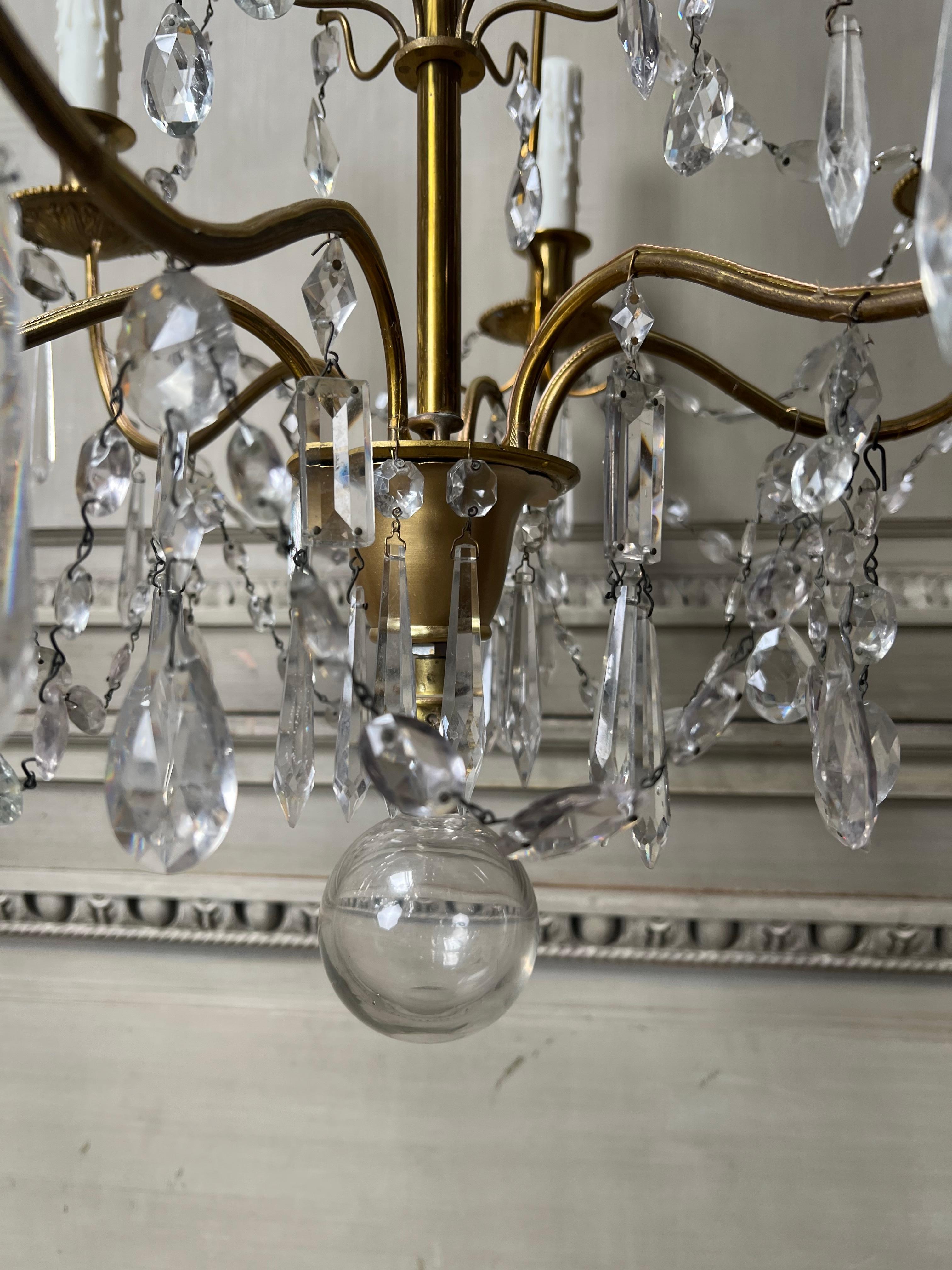 Mid-Century Modern Pair of French Brass and Crystal Chandeliers For Sale