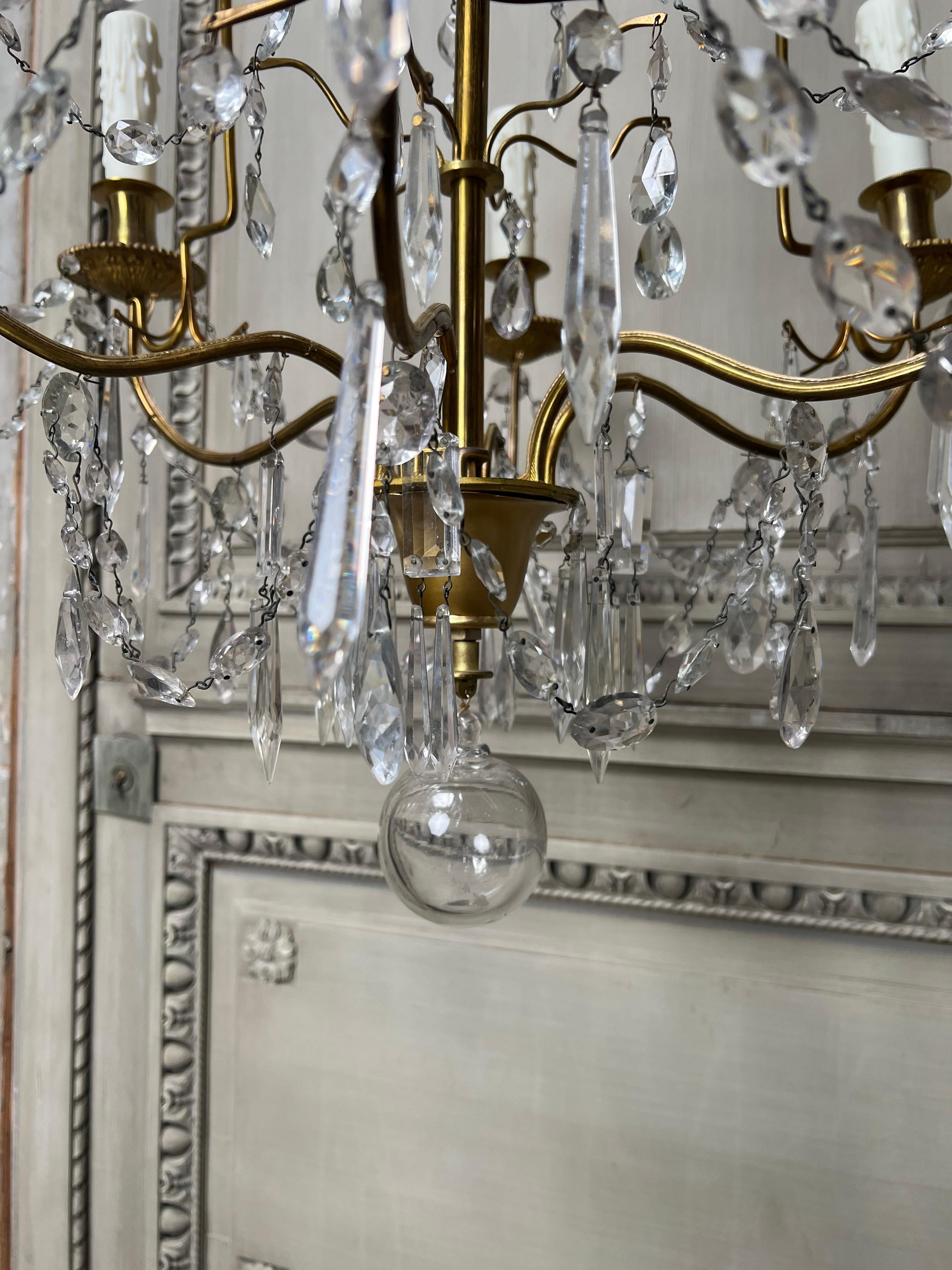 20th Century Pair of French Brass and Crystal Chandeliers For Sale