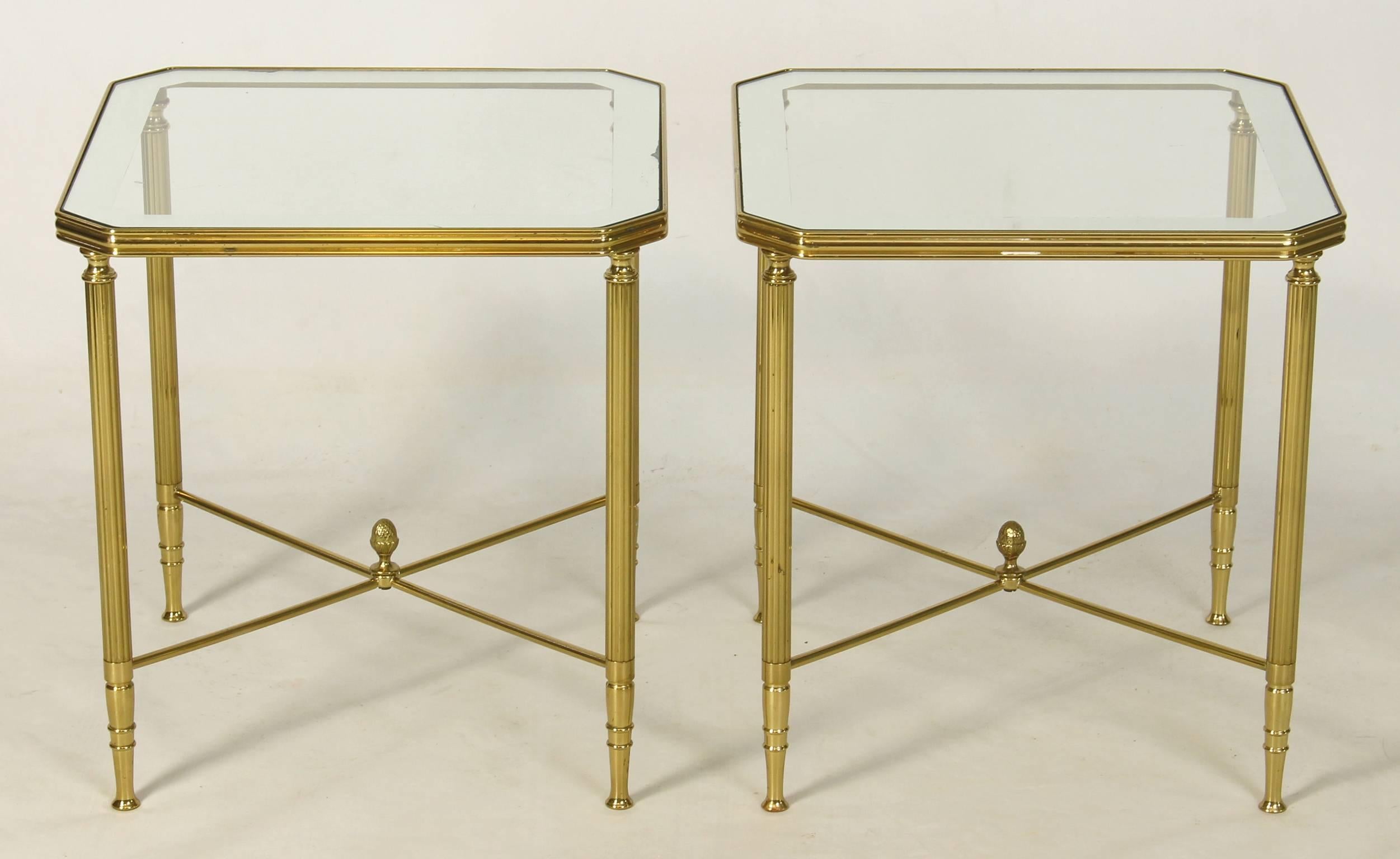 An elegant pair of mid-20th century. French solid brass side tables inset with clear glass and mirror bodered tops.