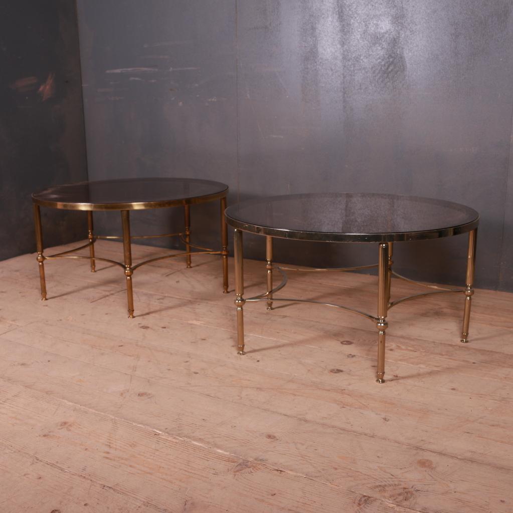 Pair of 1950s French brass and glass coffee tables, 1950s.

Dimensions:
16.5 inches (42 cms) high
30.5 inches (77 cms) diameter.