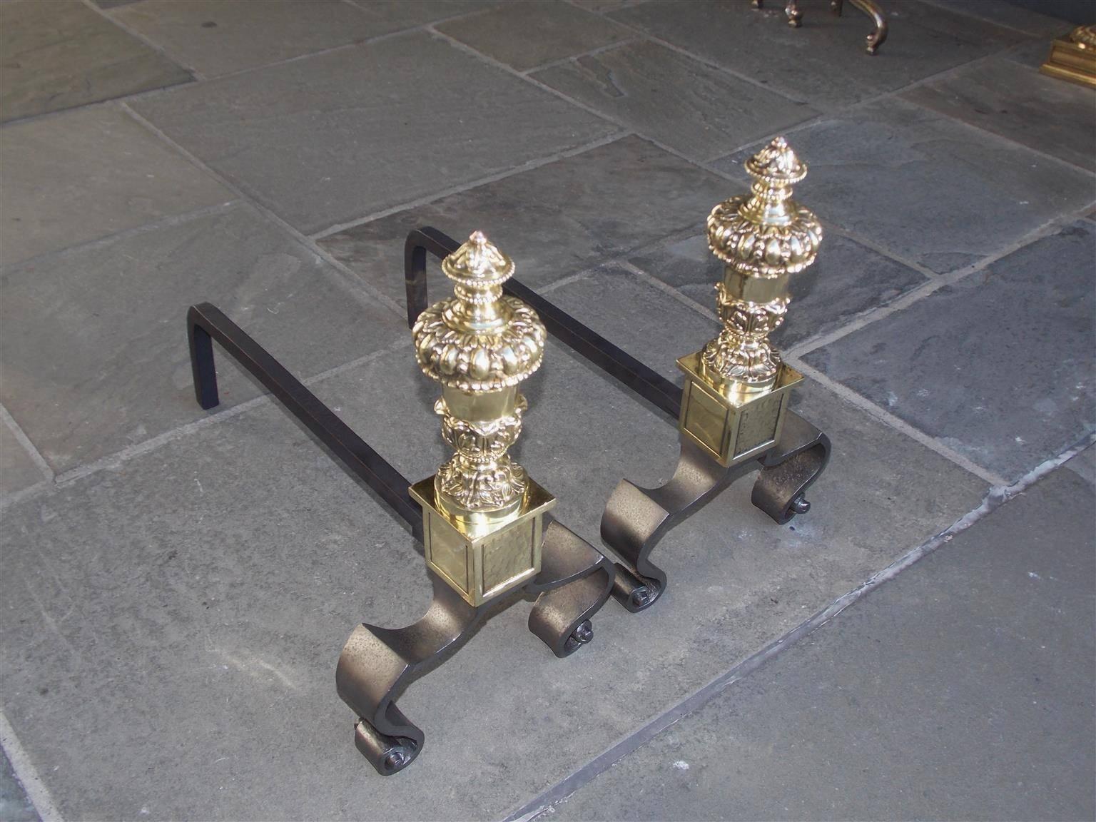 Pair of French brass and polished steel Urn finial andirons with decorative acanthus bead work, squared hand hammered plinths, and resting on outset flanking scrolled legs, Mid-19th century. Depth can be adjusted if desired at no additional cost.