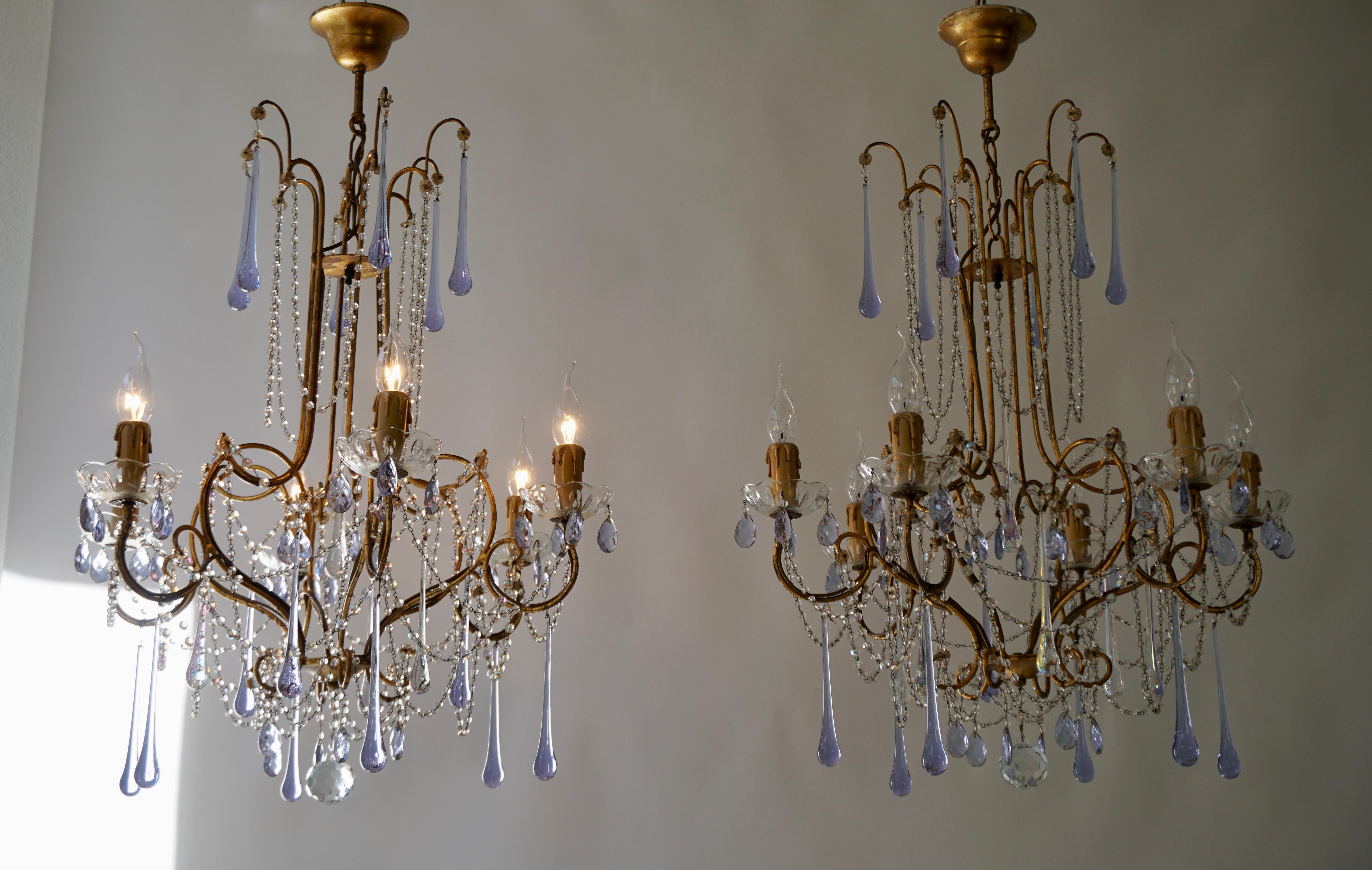 Two French six-light crystal chandeliers from the mid-20th century, with patinated brass structure and purple glass teardrops.

The light requires six single E14 screw fit lightbulbs (60Watt max.) LED compatible.

Diameter 60 cm
Height fixture 75