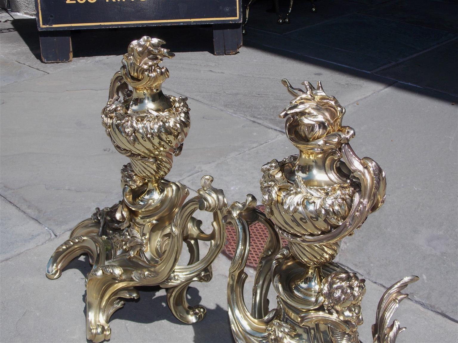 Louis Philippe Pair of French Brass Flame Urn Finial and Winged Cherub Floral Chenets, C. 1820 For Sale