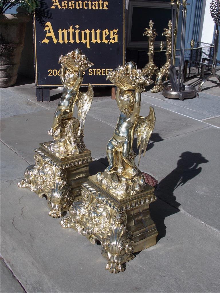 Early 19th Century Pair of French Brass Flanking Cherub Fruit Shell Andirons with Paw Feet C. 1815