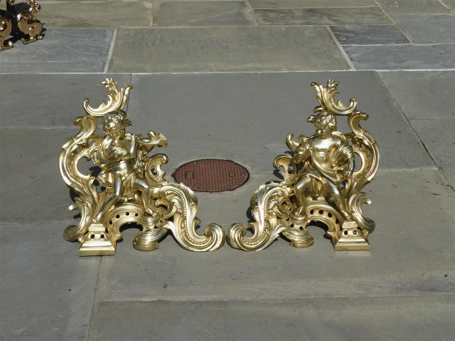 Louis Philippe Pair of French Brass Flanking Figural Musical & Foliage Scrolled Chenets, C 1810 For Sale