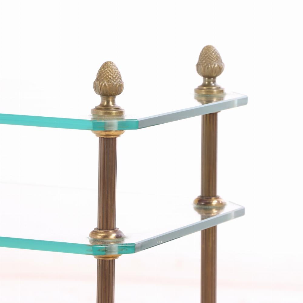Une paire de petites tables d'appoint à trois niveaux de bonne qualité ! Chaque table est dotée d'un cadre en laiton raffiné aux détails néoclassiques et de trois niveaux d'étagères en verre, offrant à la fois style et fonctionnalité dans un espace