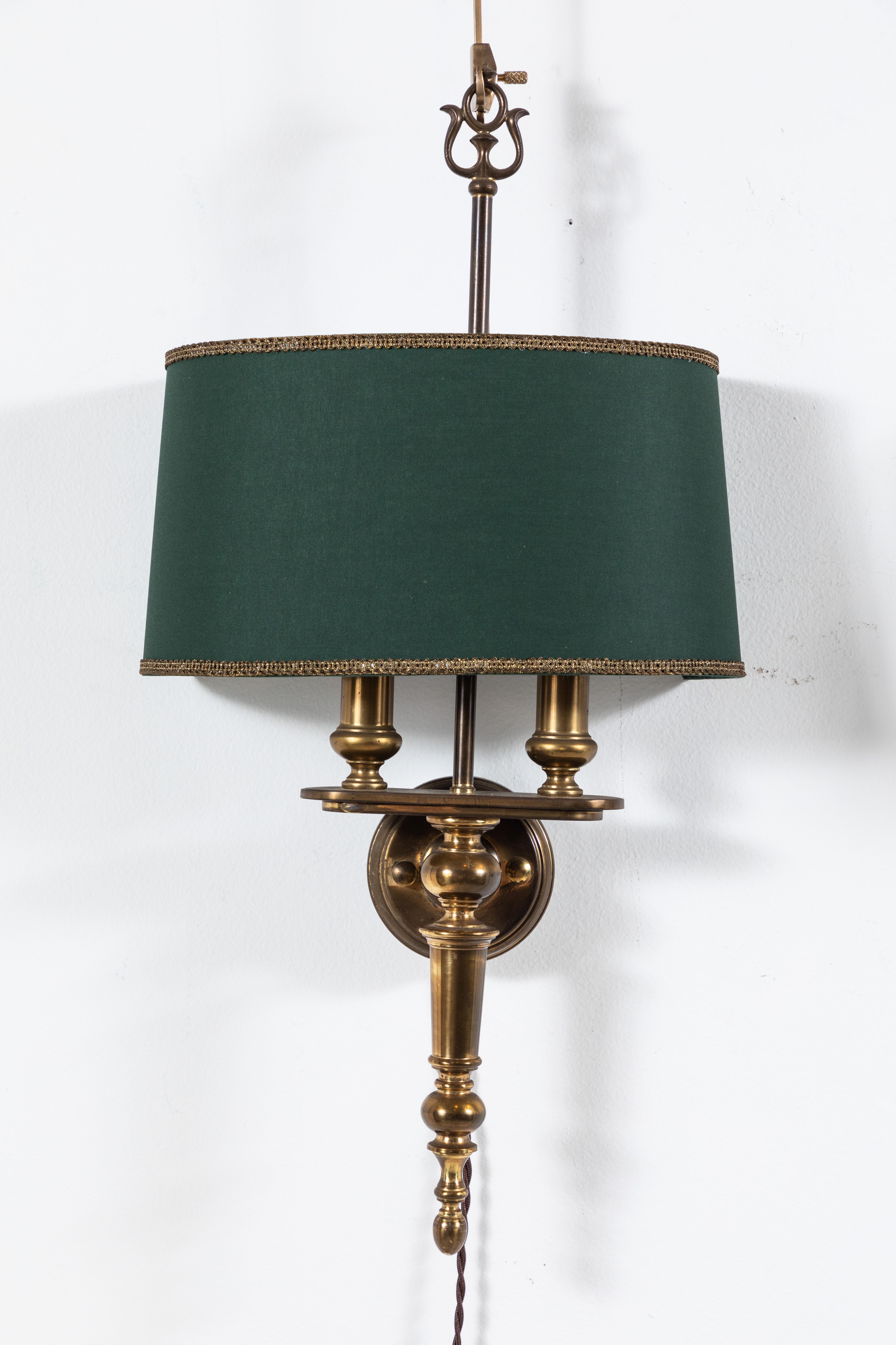 Beautiful Classical inspired pair of French brass two socket sconces with green book cloth shade with gold trim on the top and bottom.