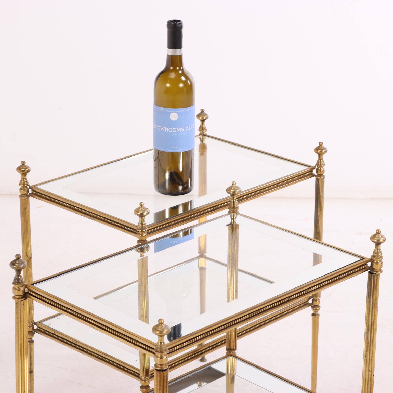20th Century Pair of French Brass Two-Tier Tables, in the manner of Maison Jansen, C. 1960. For Sale