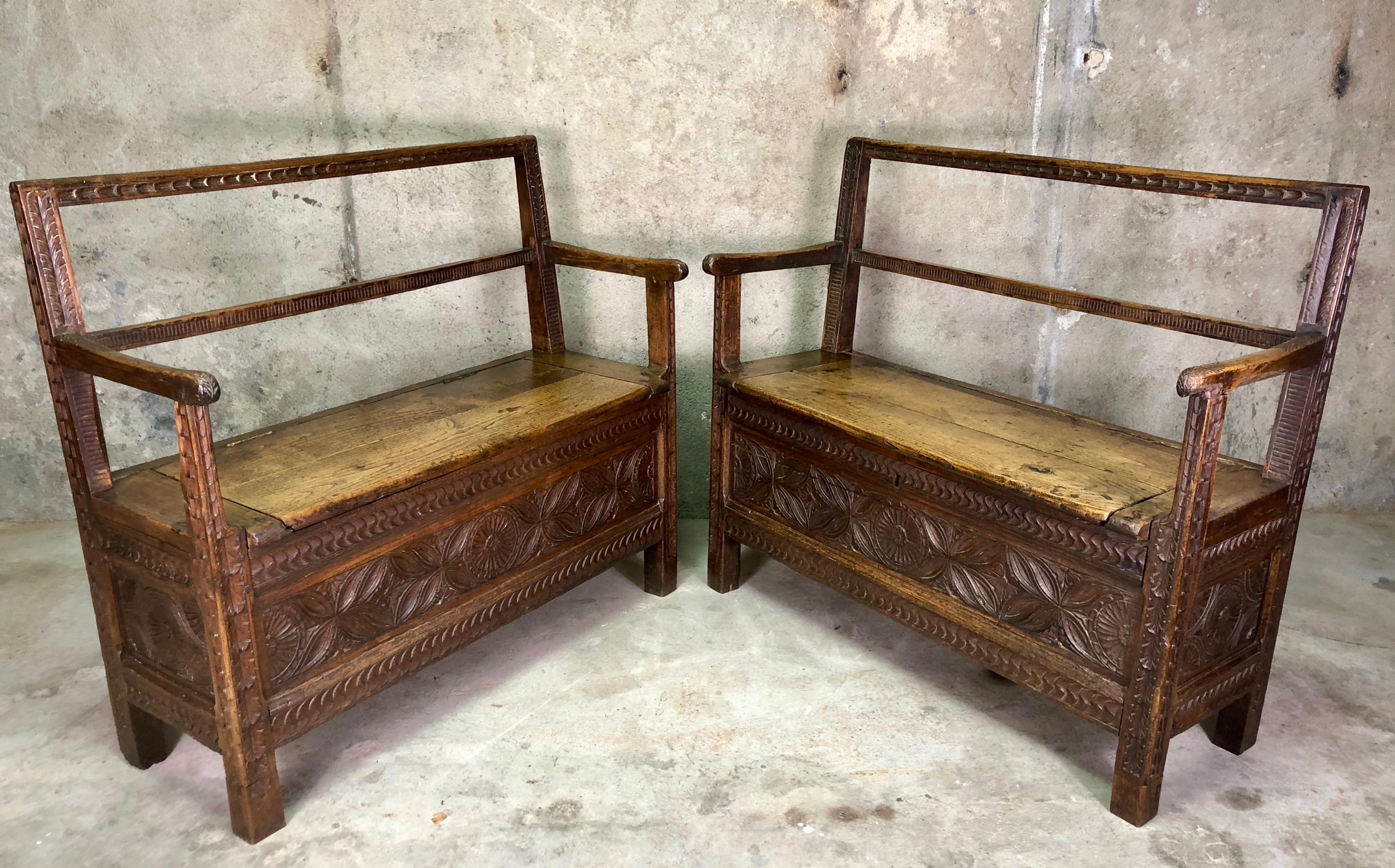 A rare pair of hand-crafted Breton (France) benches with lift up seats to provide storage inside.
They are hand-carved from oak in a typical Breton style with a rustic, country look.
It is rare to find a pair of these benches together in the same