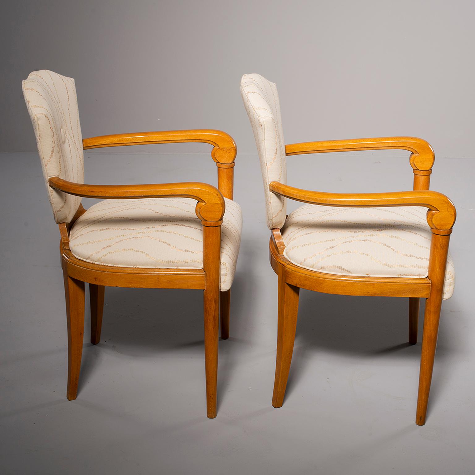 Pair of circa 1940s French bridge chairs have polished beech frames with curved arms, shield-shaped back rests and are newly upholstered in Robert Allen fabric in neutral tones. Measures: Arms are 25.25” high and seats are 19.75” high. Priced and