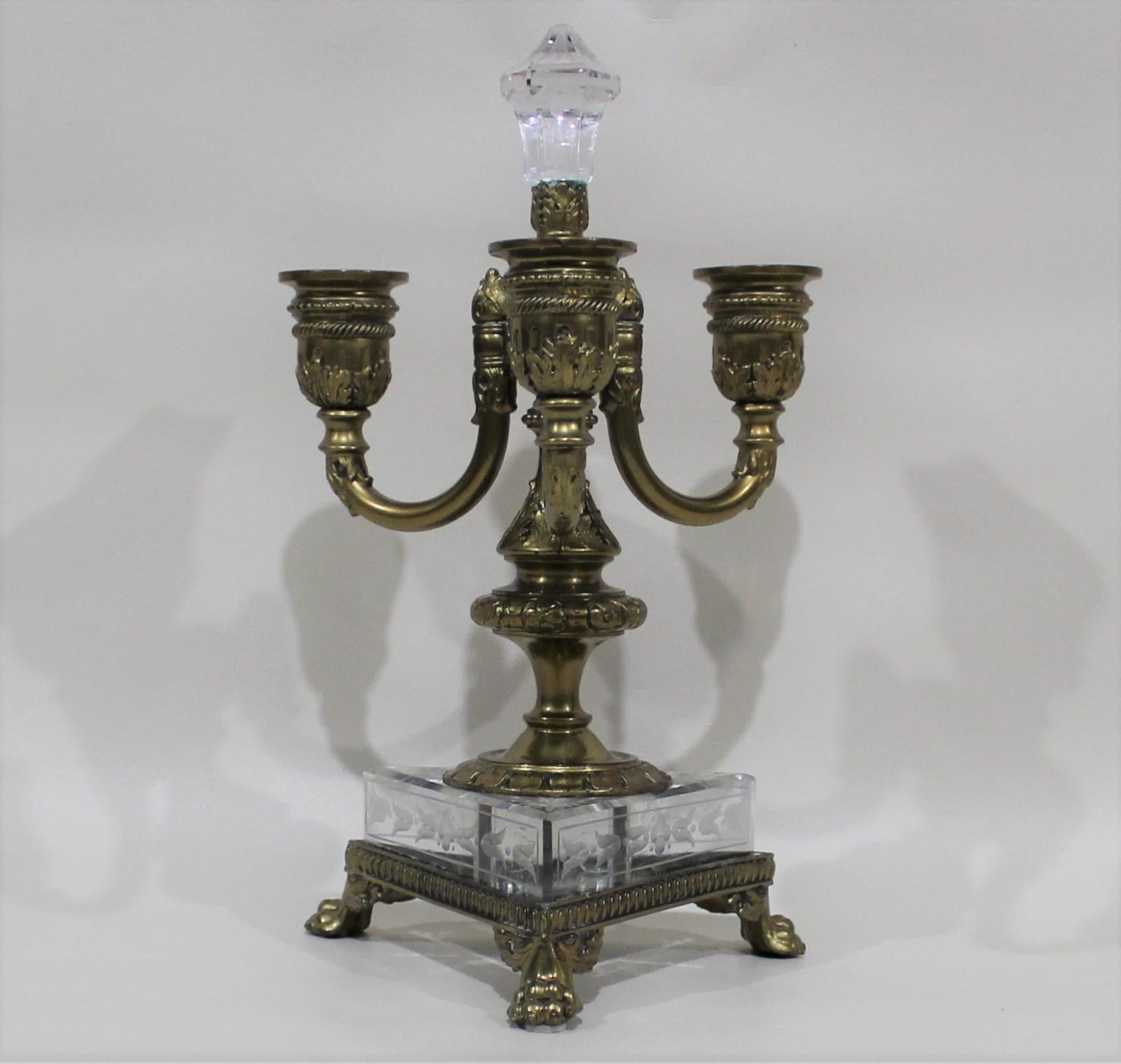 Pair of French bronze 3-arm candelabras with paw feet and etched glass base.