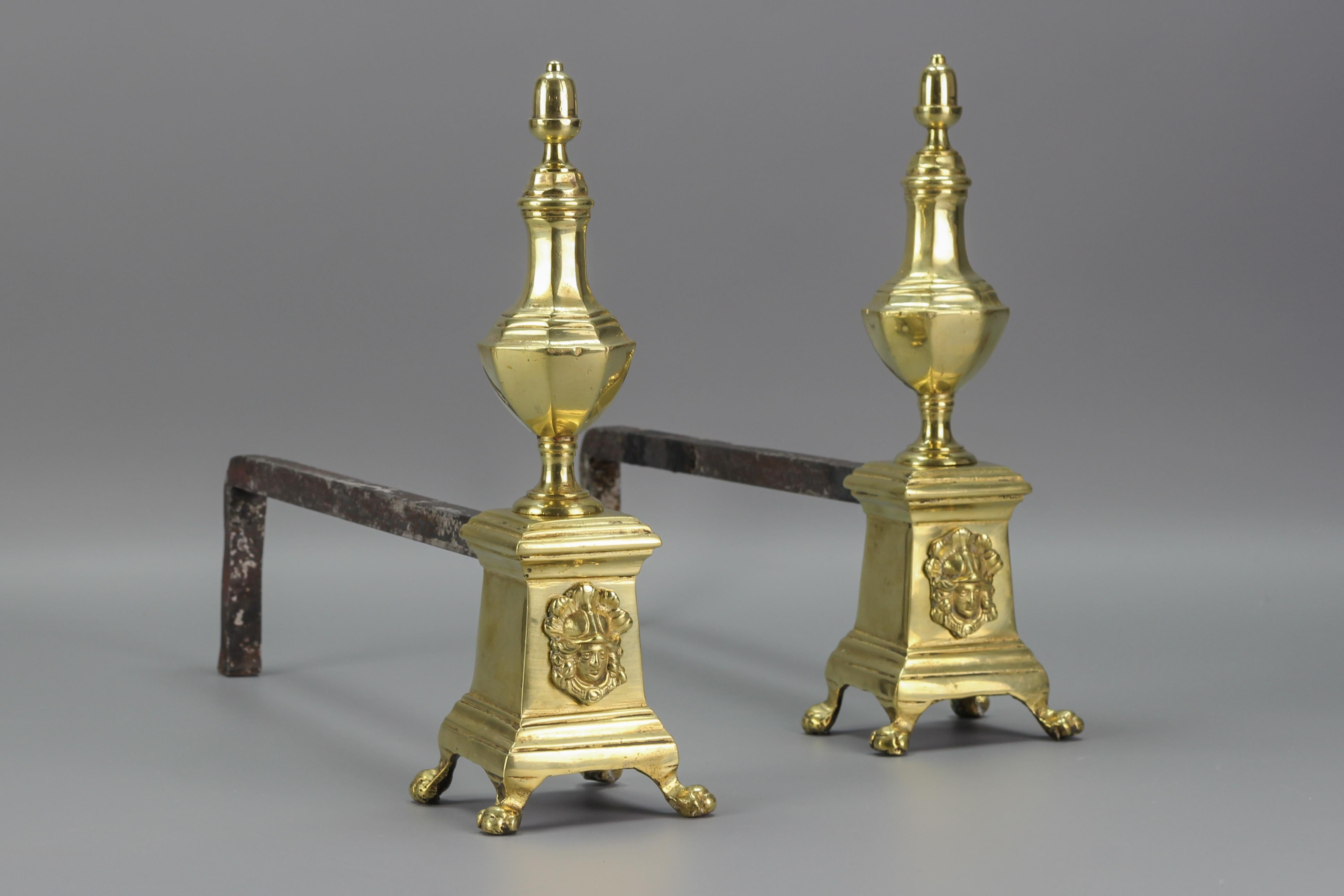 A pair of antique firedogs made of bronze and iron, France, early 20th Century. These marvelous firedogs or andirons feature bronze construction in baluster form, raised on paw feet, decorated with the goddess's face on the front.
In good condition