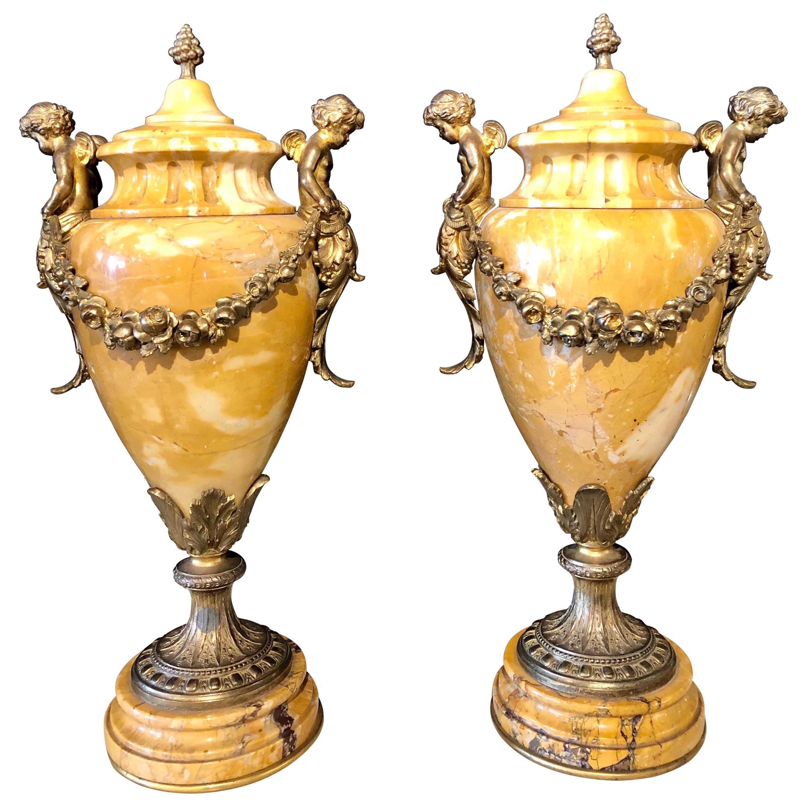 Pair of French Bronze and Marble Cassolettes Each with Cherubs